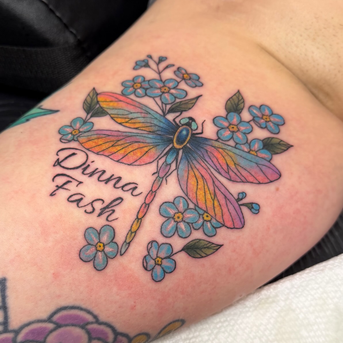 Dragonfly and forget-me-nots new school tattoo on the forearm by Jessica Oram Brockman, Dayton, Ohio