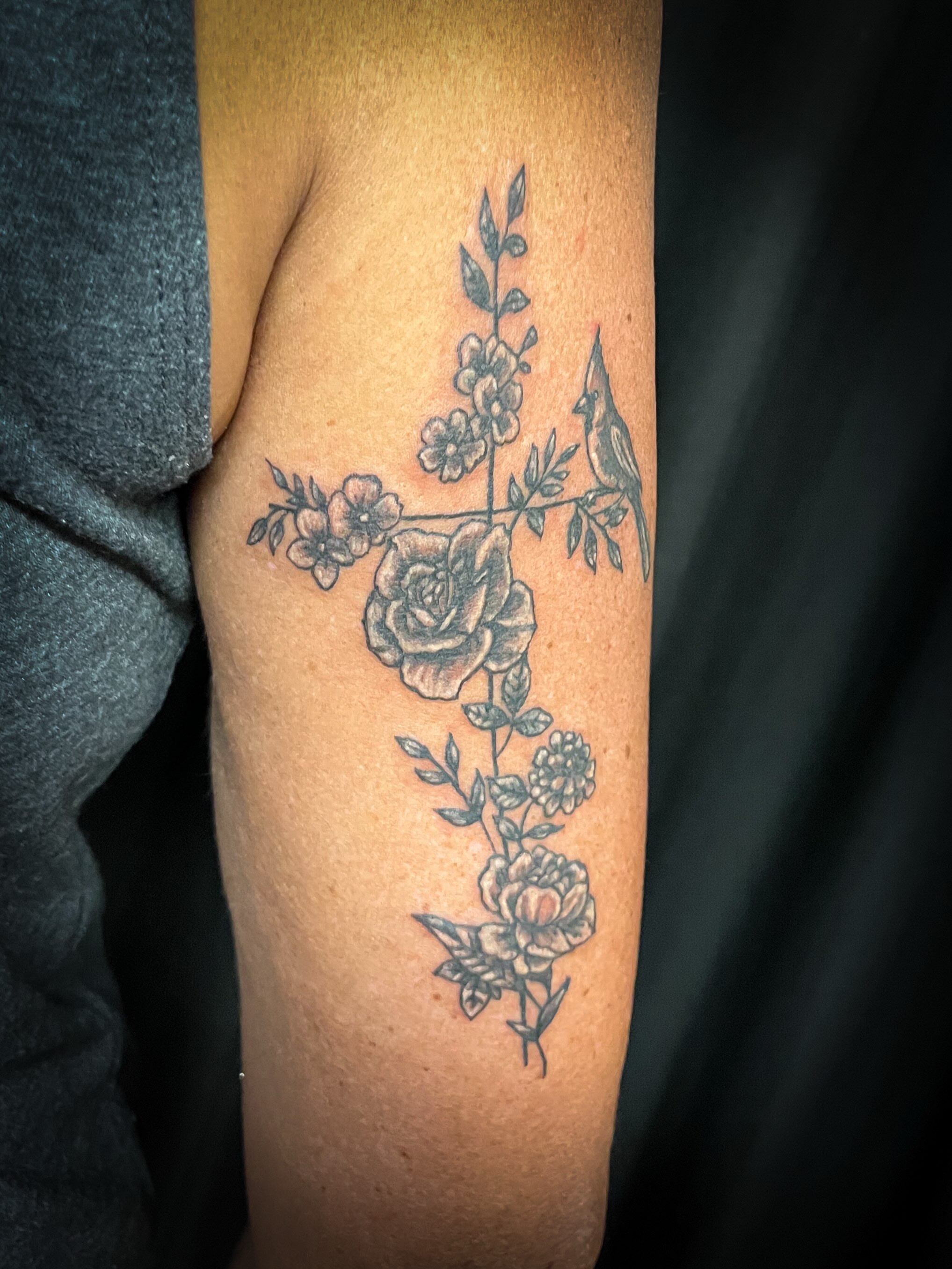 Floral cross with bird black and grey tattoo on the forearm by Melissa Peña NYC