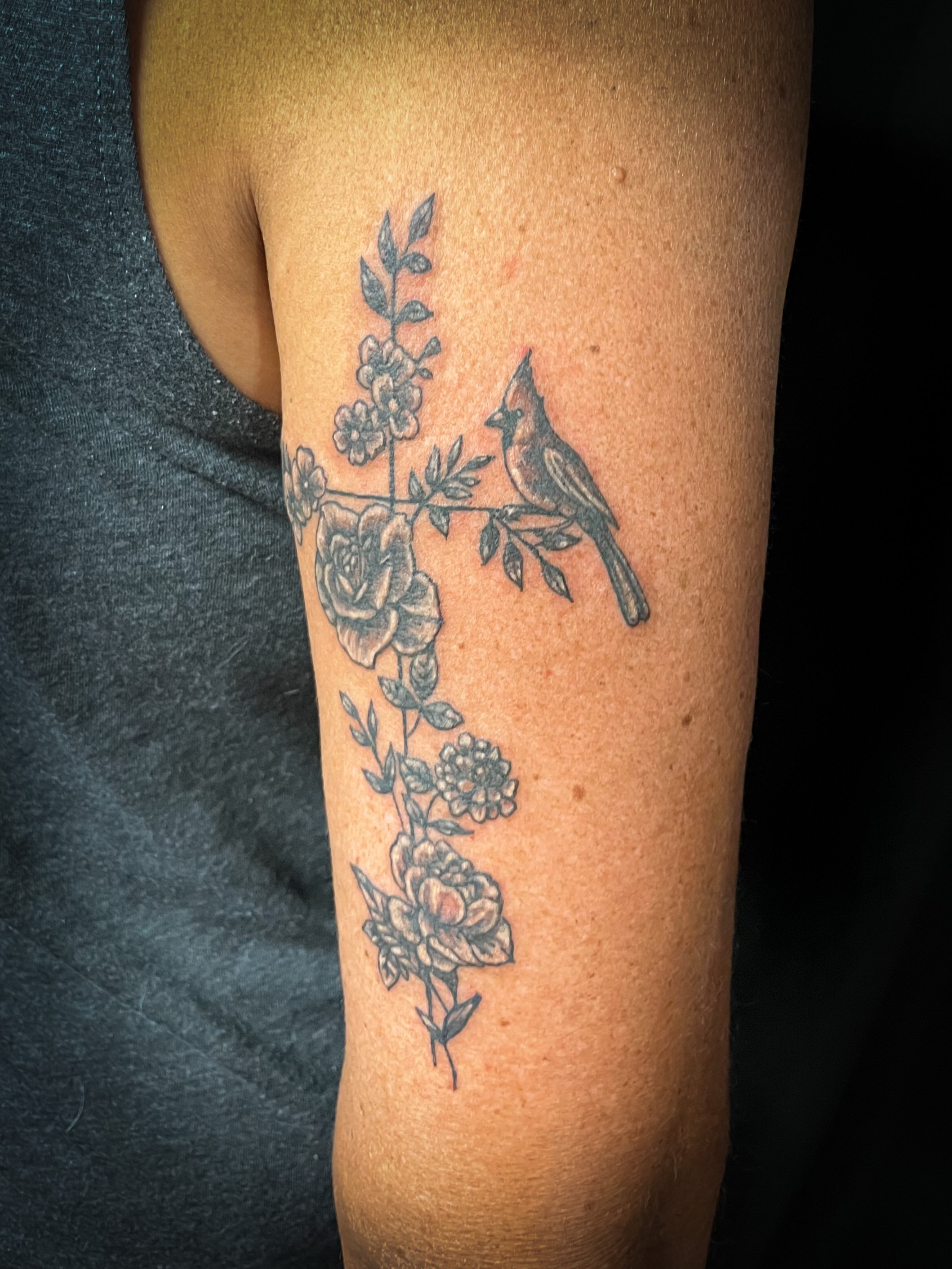 Bird and floral cross black and grey tattoo on the forearm by Melissa Peña NYC