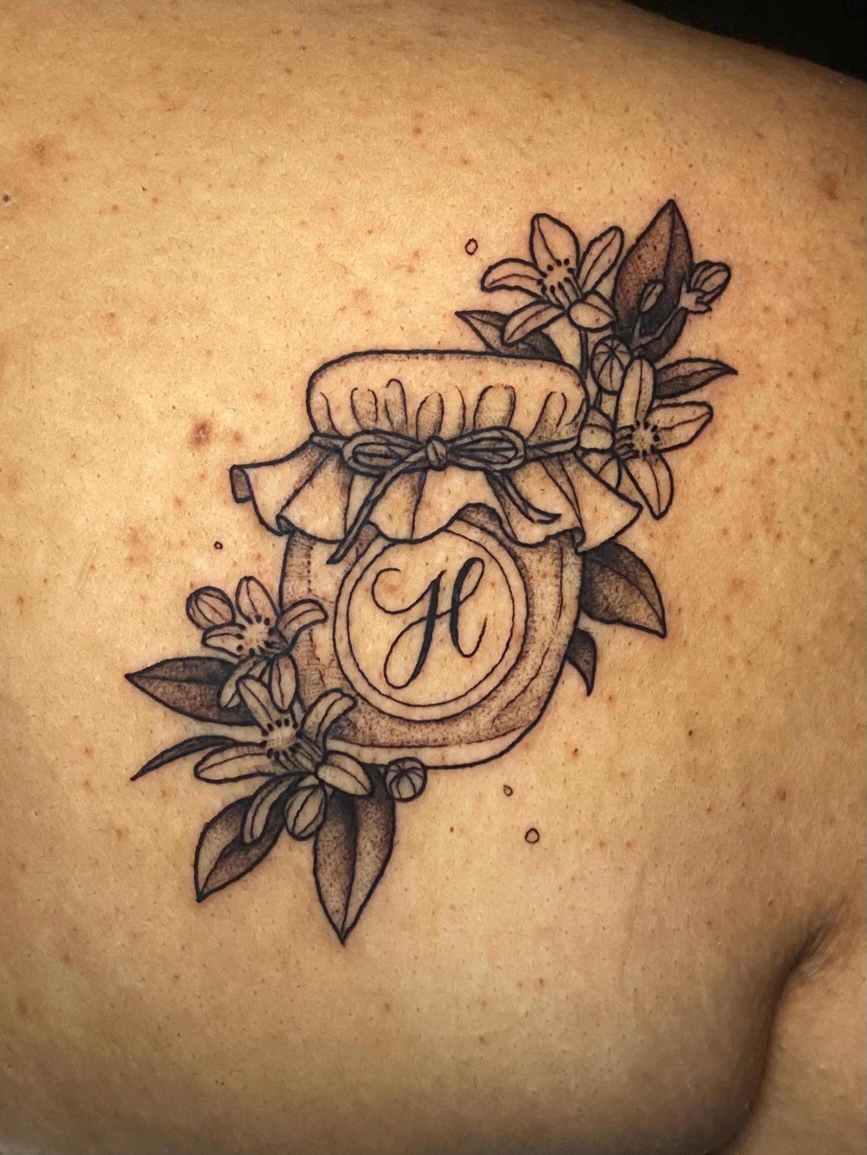 Jar with floral decoration black and grey tattoo on the back by Dawn Carr, Richmond, Virginia
