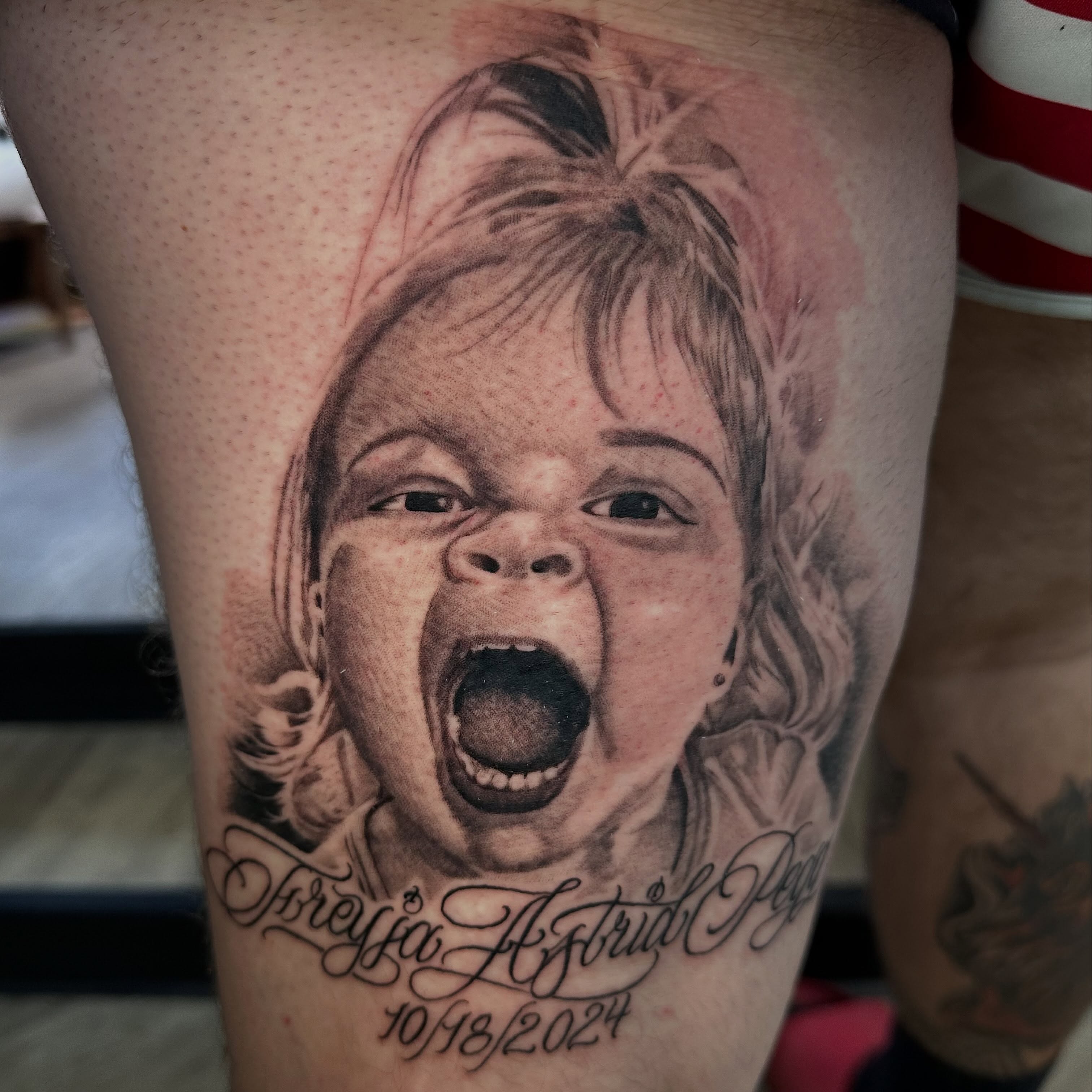 Child's face realism tattoo on the thigh by Dustin Clark, Dayton, Ohio