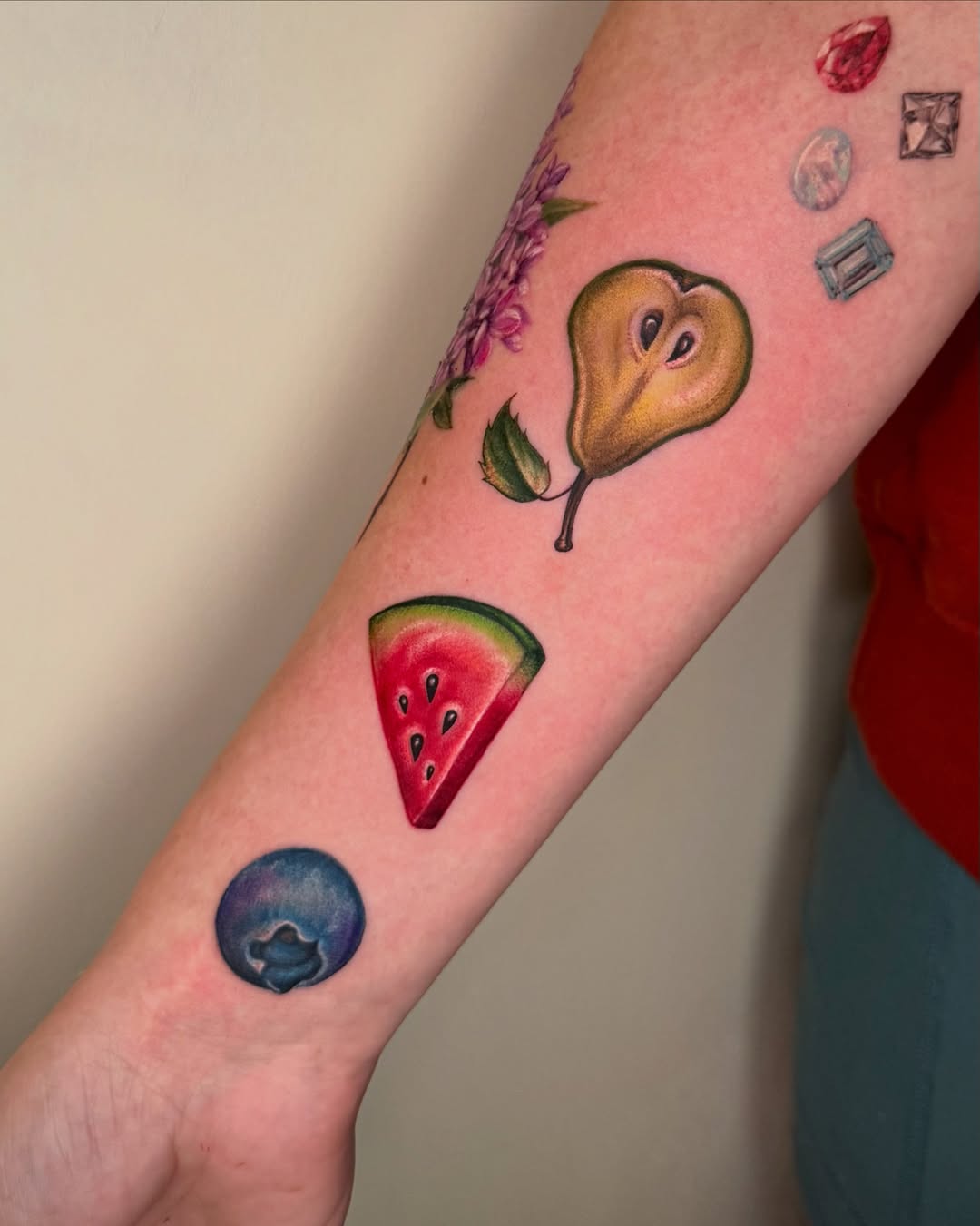 Fruit slice realism tattoo on the forearm by Nichole Lorence