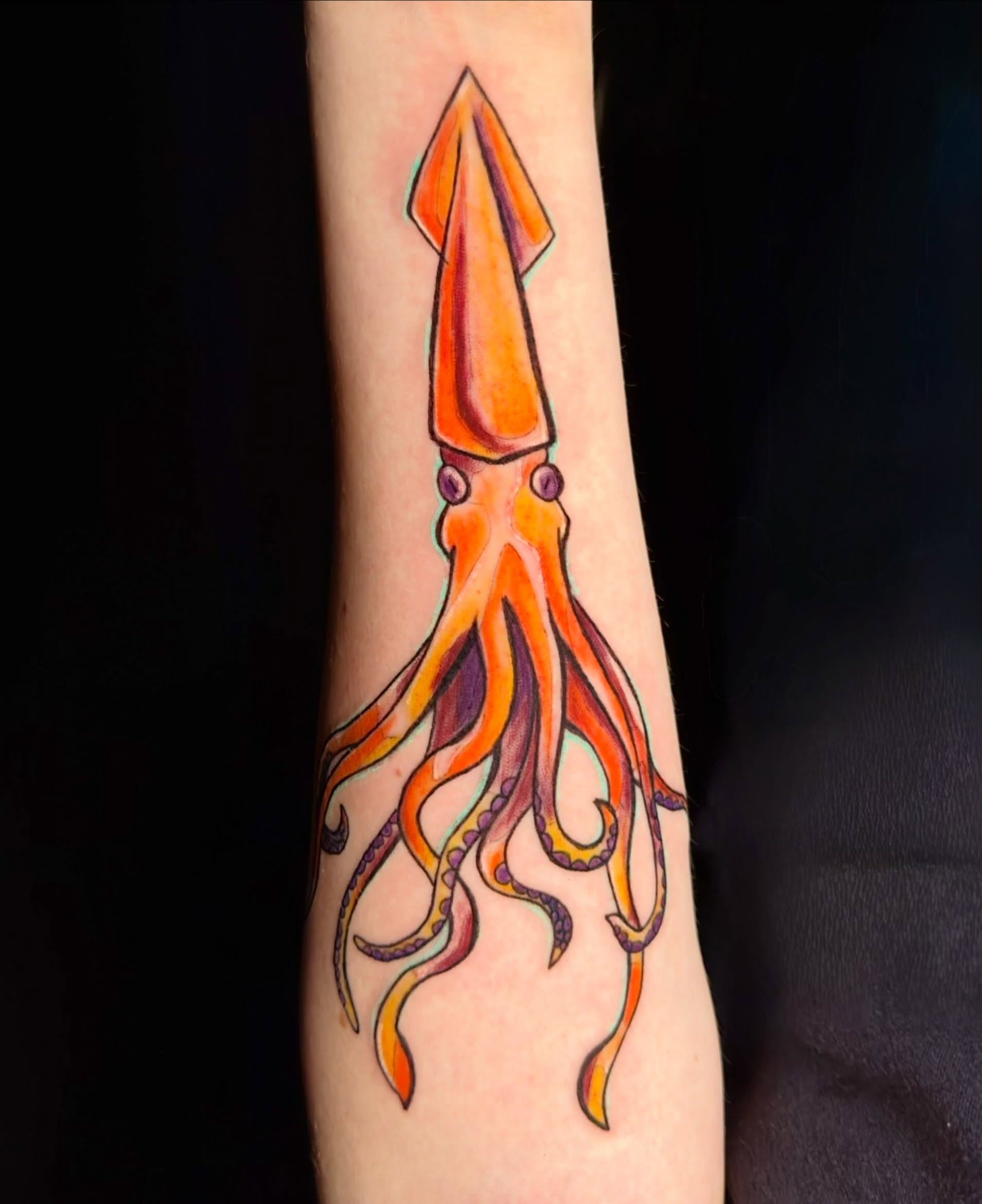 Squid watercolor tattoo on the forearm by Charlotte (Luna), Seattle, Washington