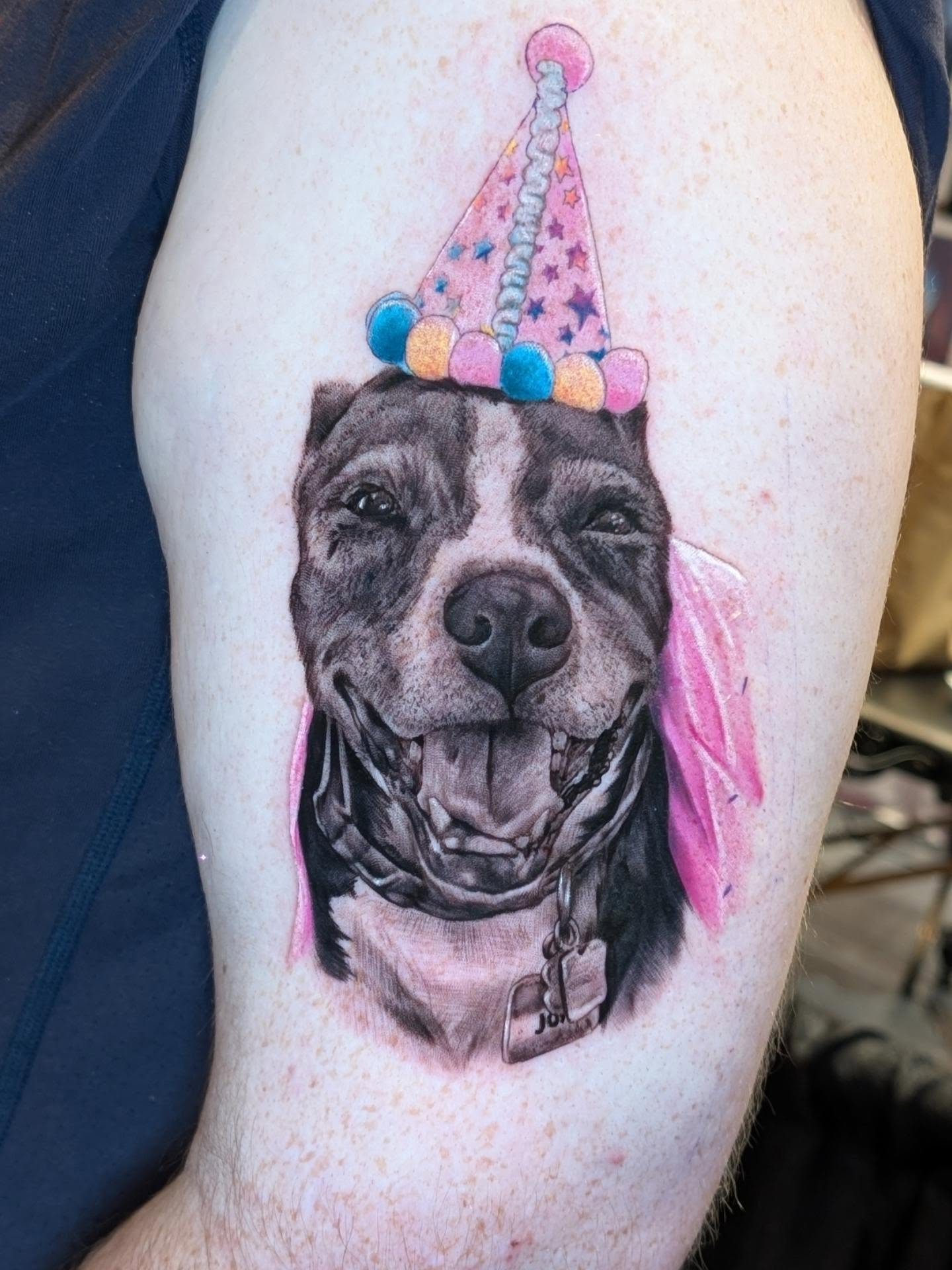 Dog wearing party hat realism tattoo on the thigh by Will Alexander, Lombard, Illinois