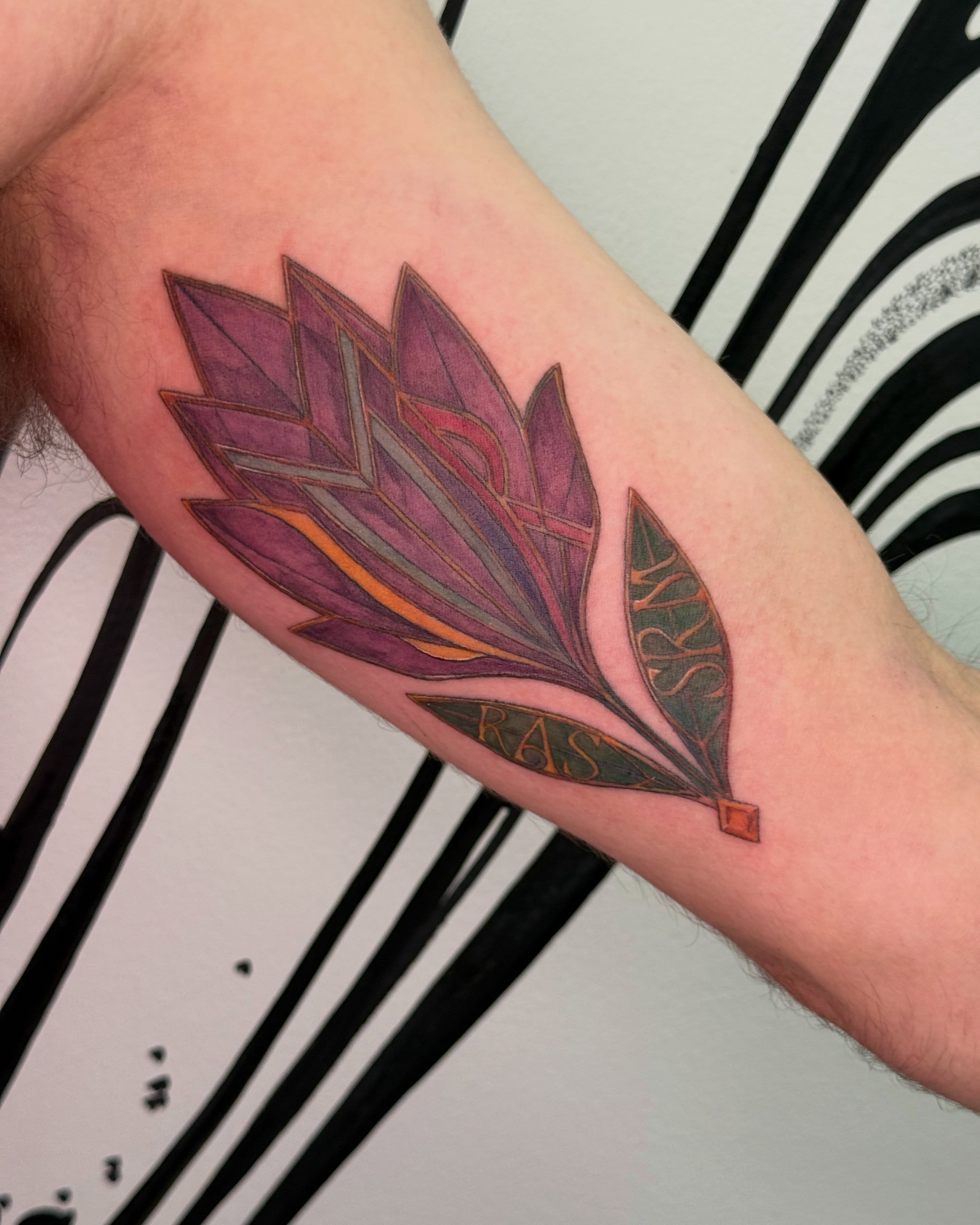 Feather geometric tattoo on the forearm by Brows & Tattoos