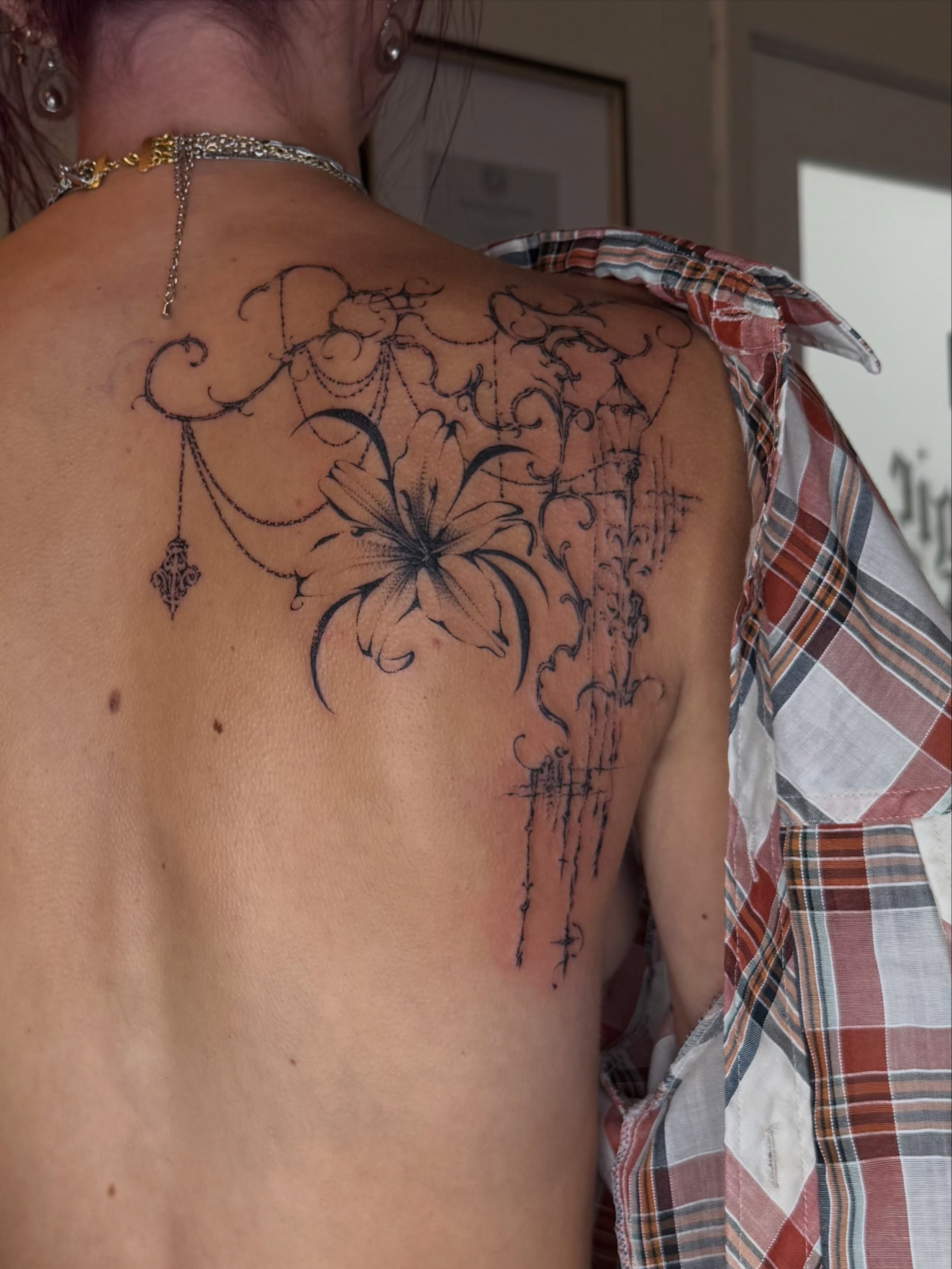 Floral design black and grey tattoo on the back by Maggie Angulo