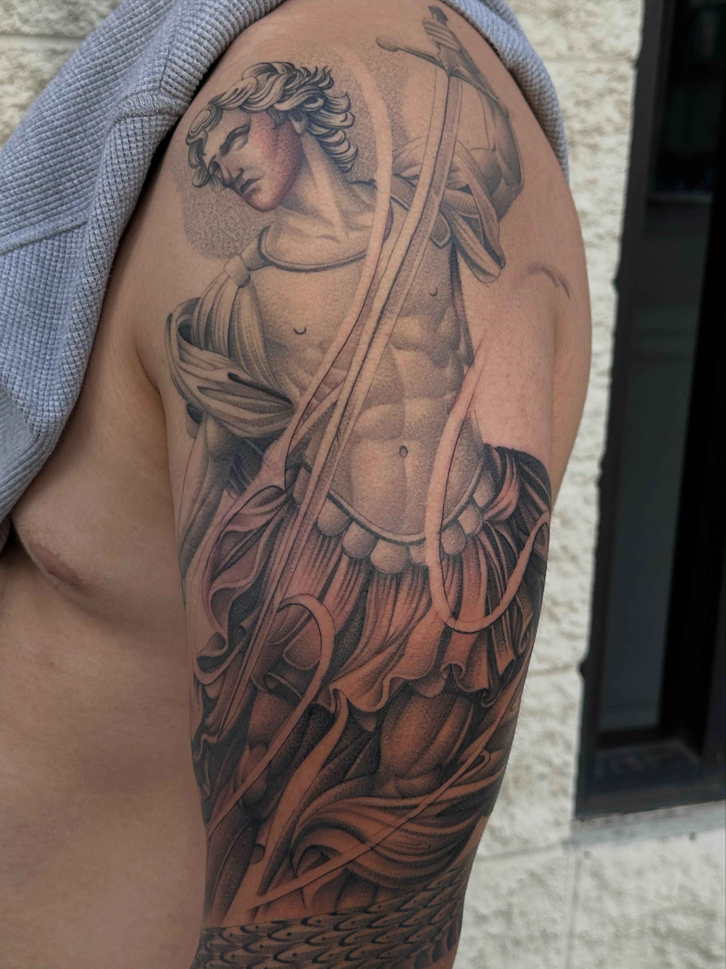 Statue of saint realism tattoo on the shoulder by San Diego Tattoo Artist