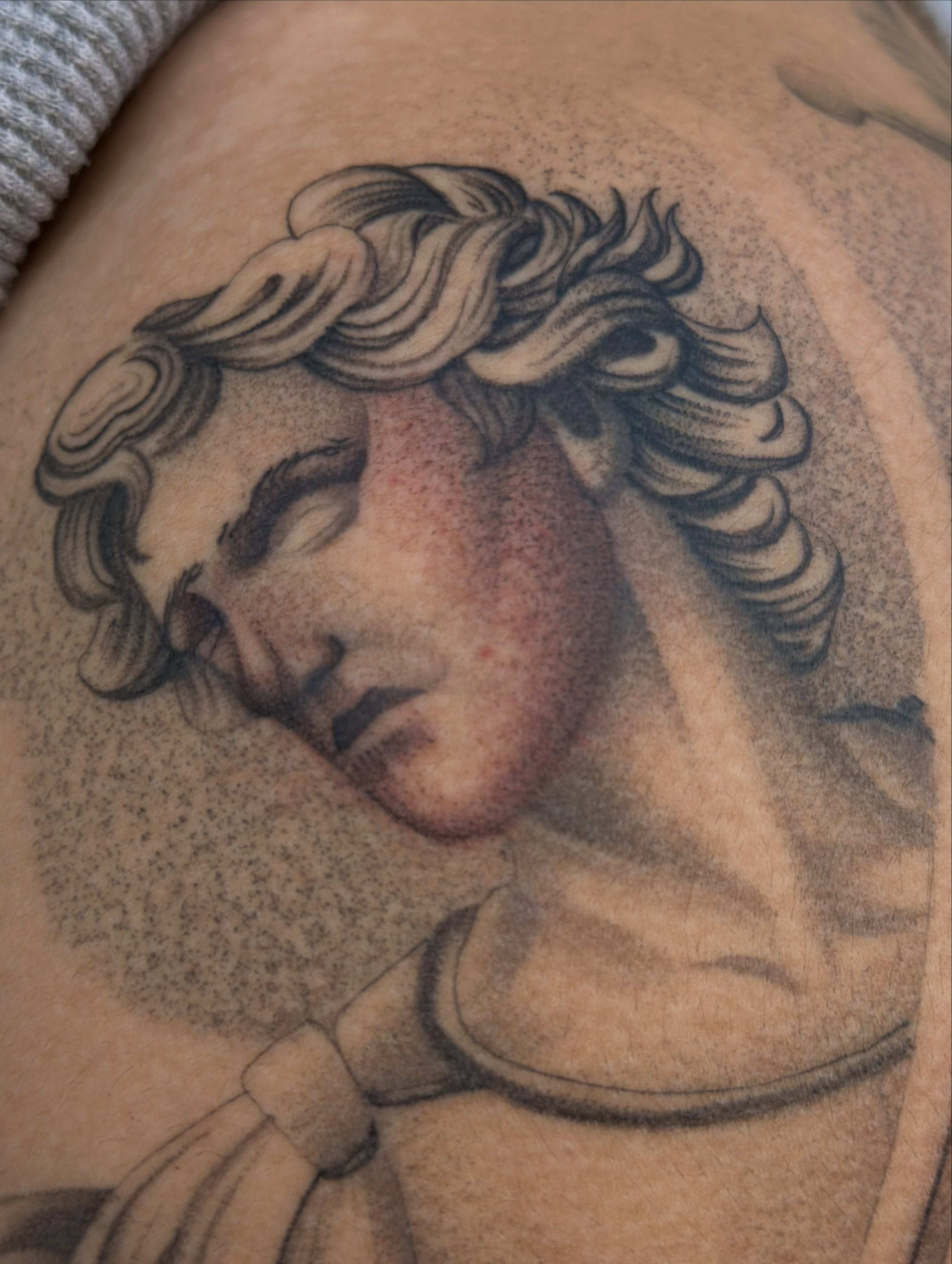 Statue head realism tattoo on the shoulder by San Diego Tattoo Artist