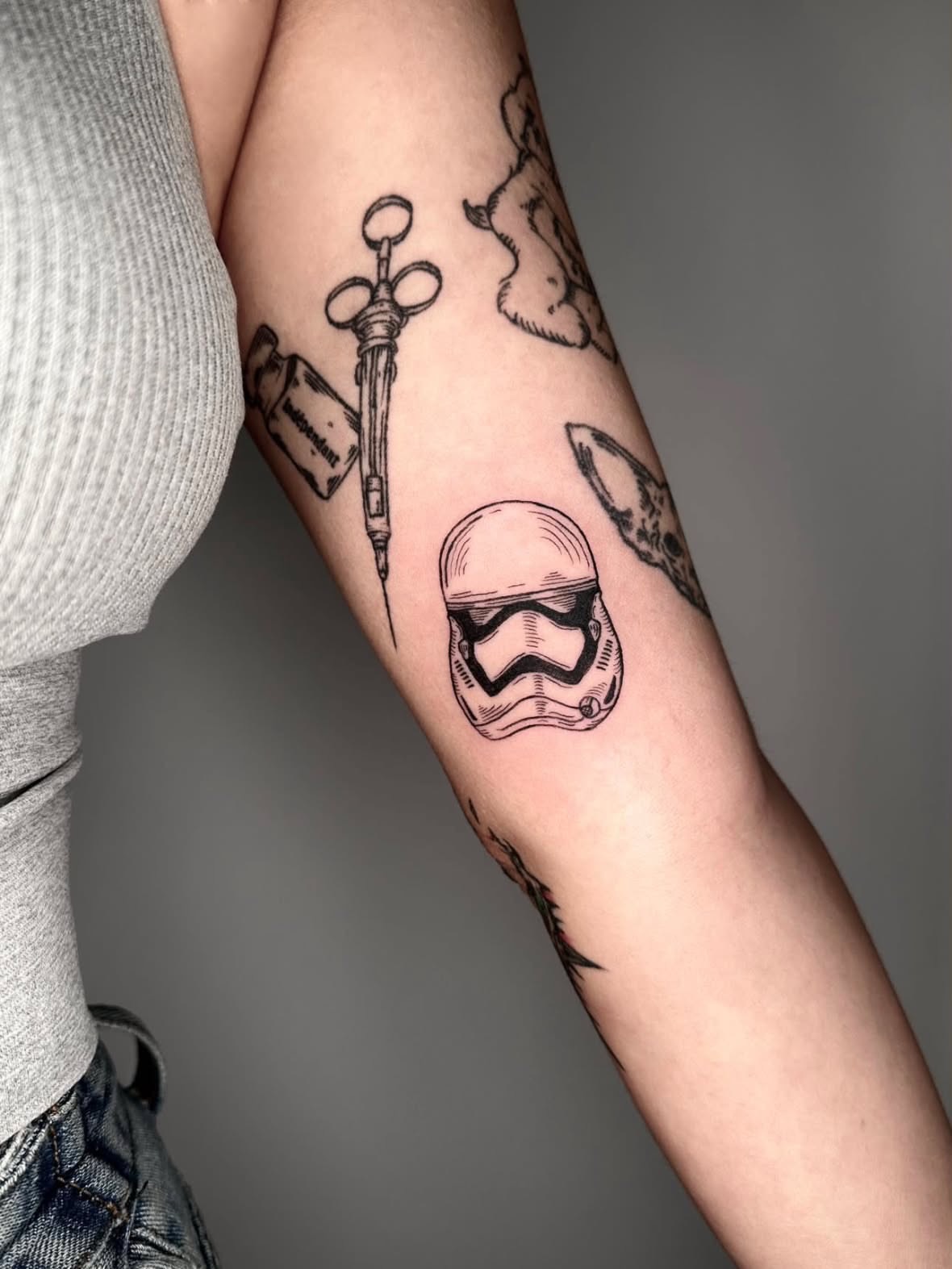 Trooper helmet black and grey tattoo on the forearm by Zecember