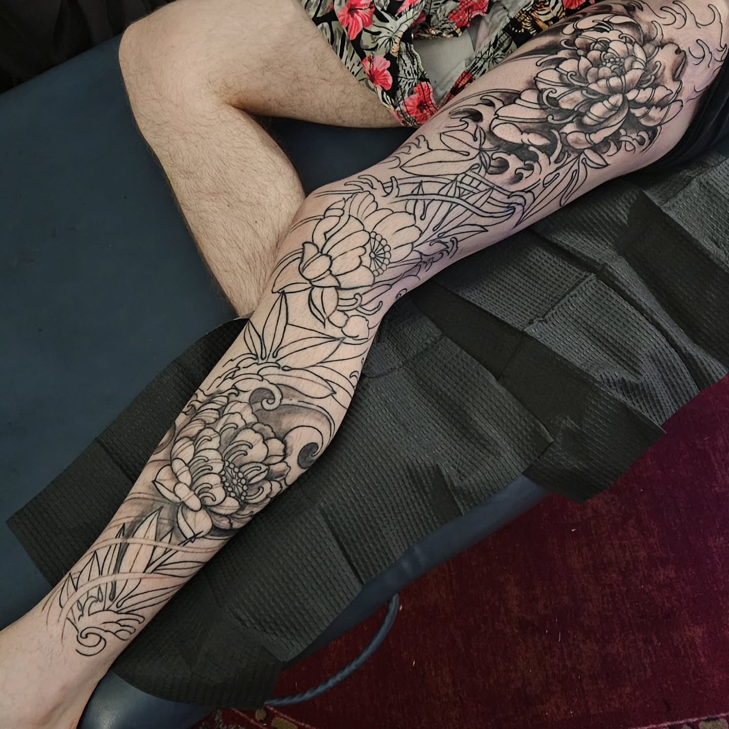 Floral design black and grey tattoo on the forearm by Shane Watkins