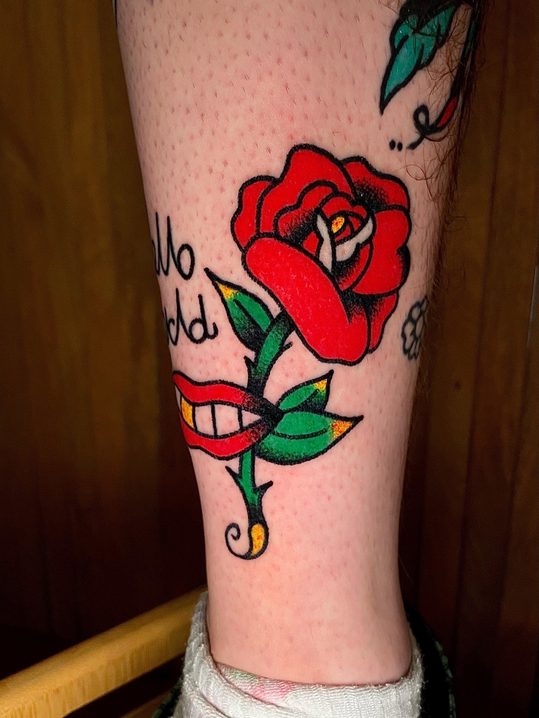 Red rose American traditional tattoo on the forearm by Daniel Diego