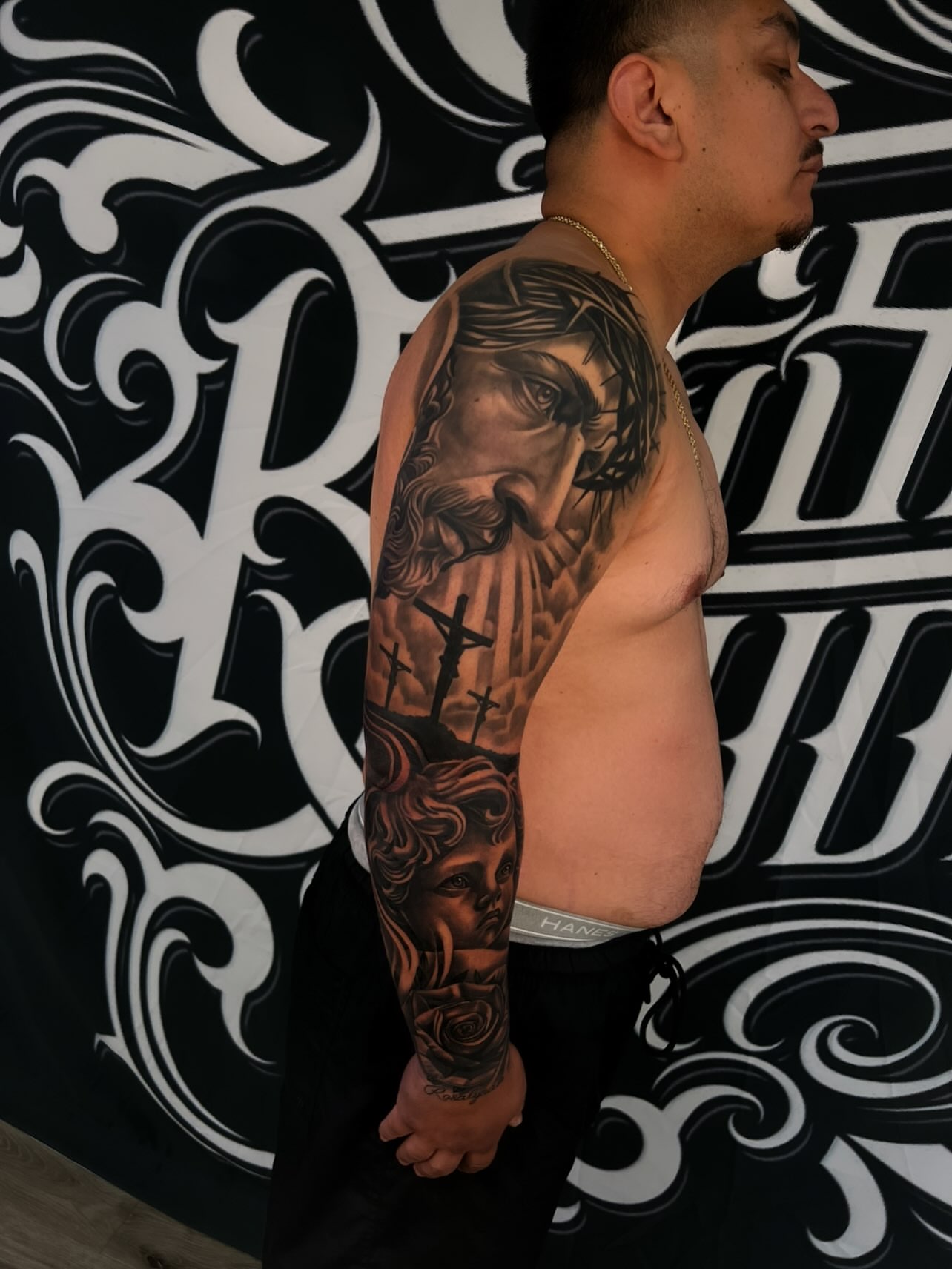 Religious figures realism tattoo on the upper arm by Daniel Michael Perez
