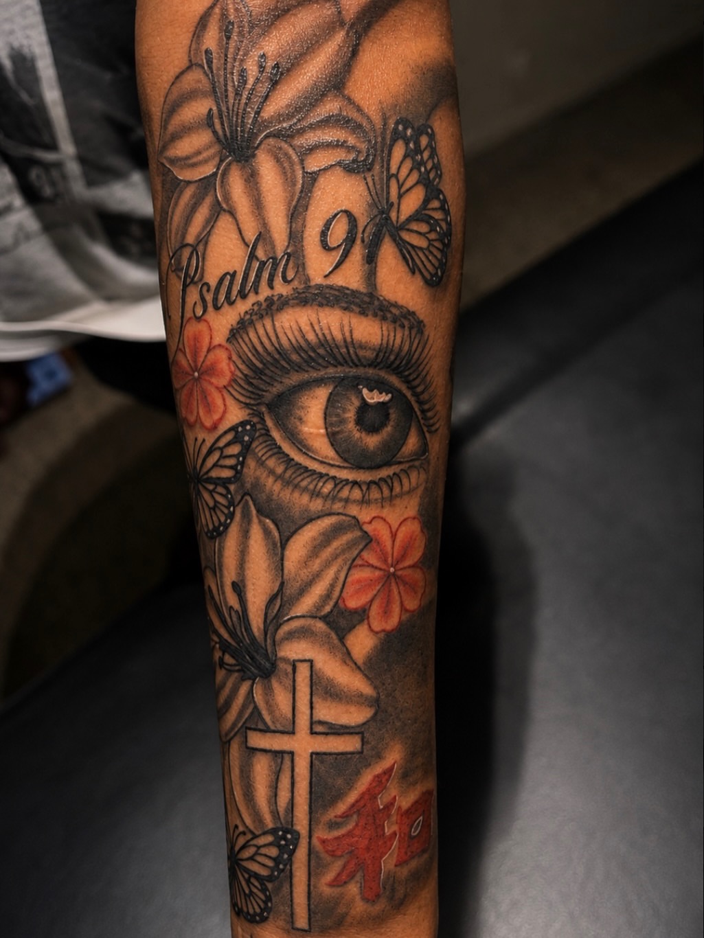 Eye and floral motifs realism tattoo on the forearm by @tatzbythadon