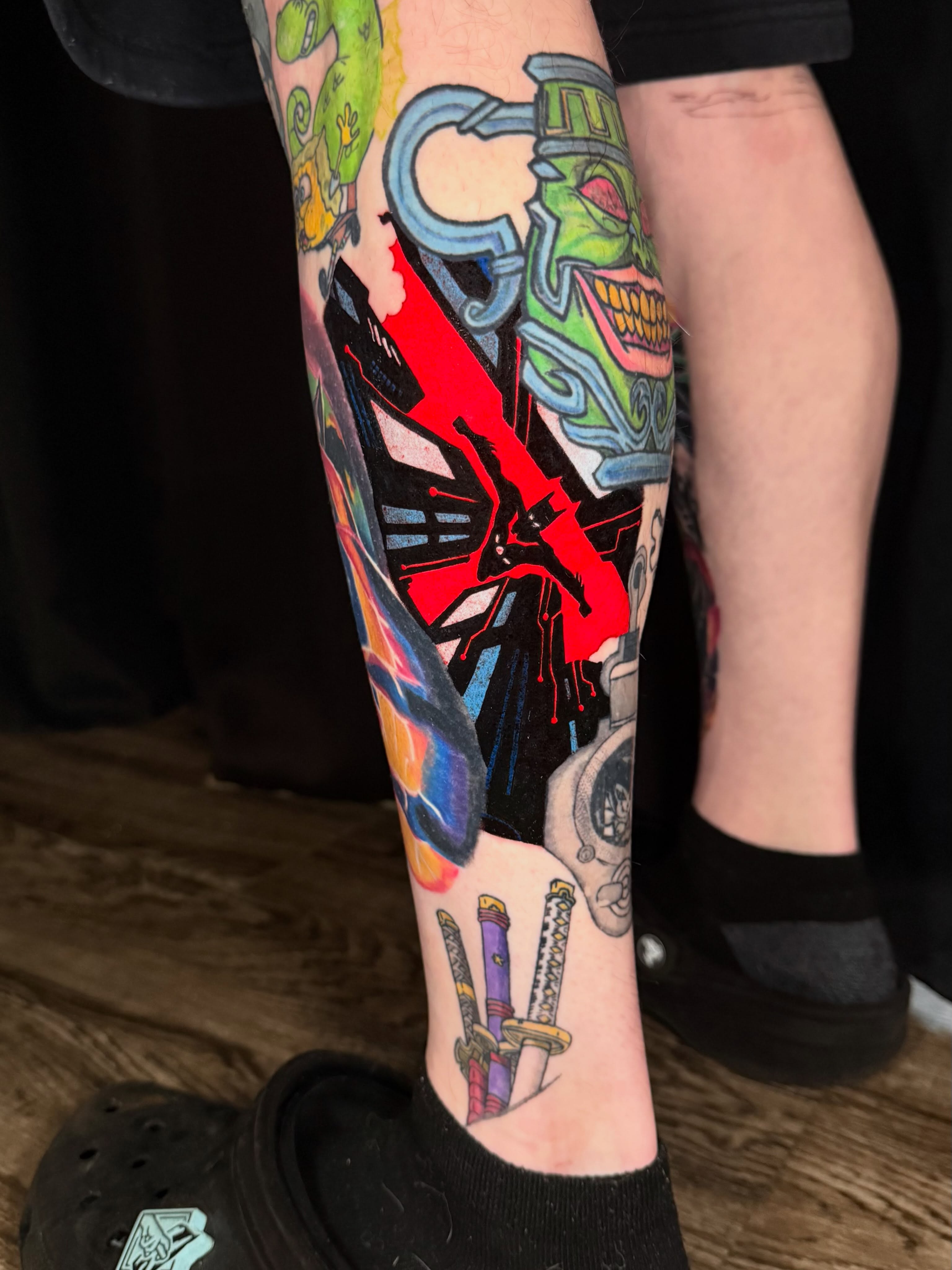 Cyborg skull with red cross new school tattoo on the calf by Damon Moore