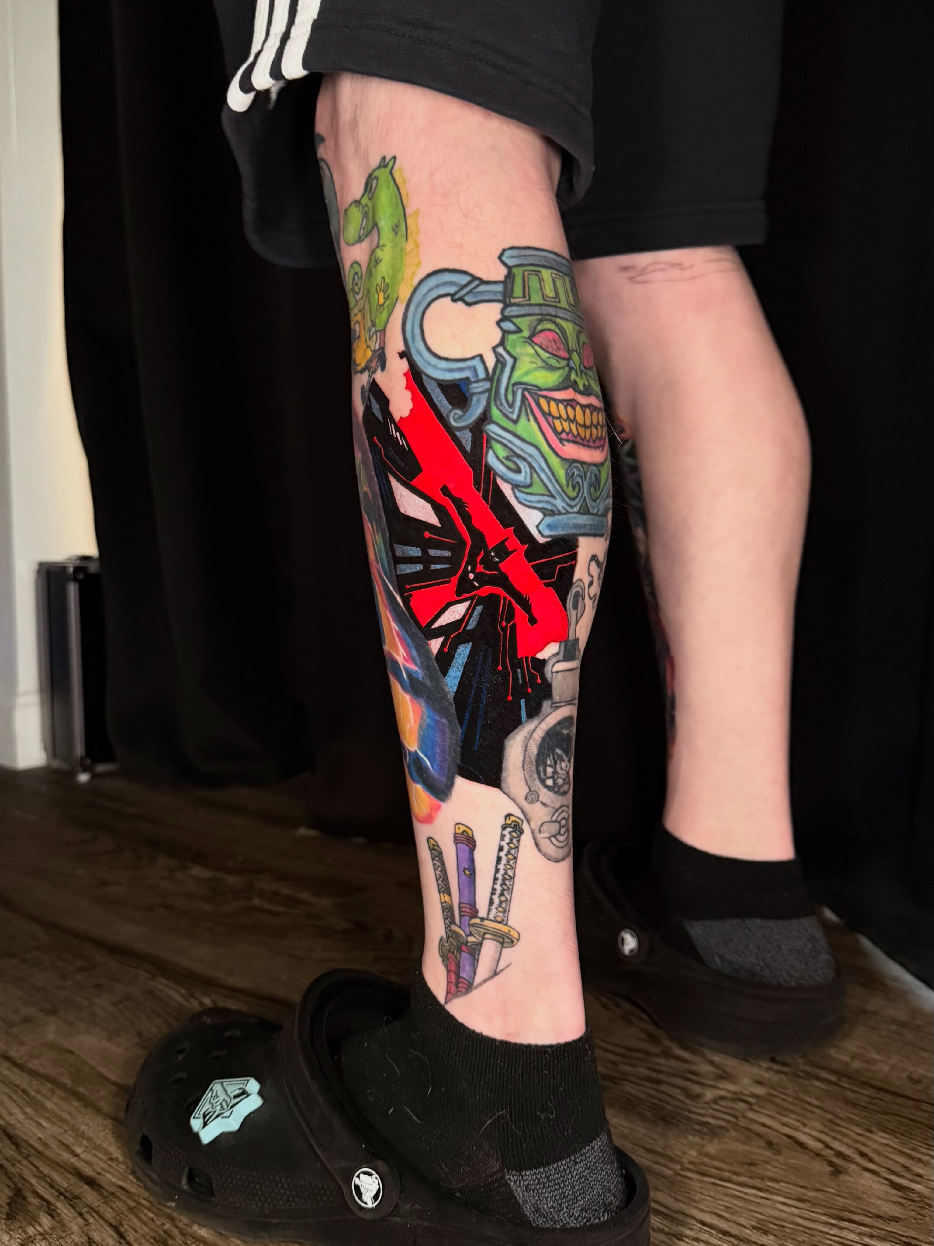 Monster and weapons American traditional tattoo on the calf by Damon Moore