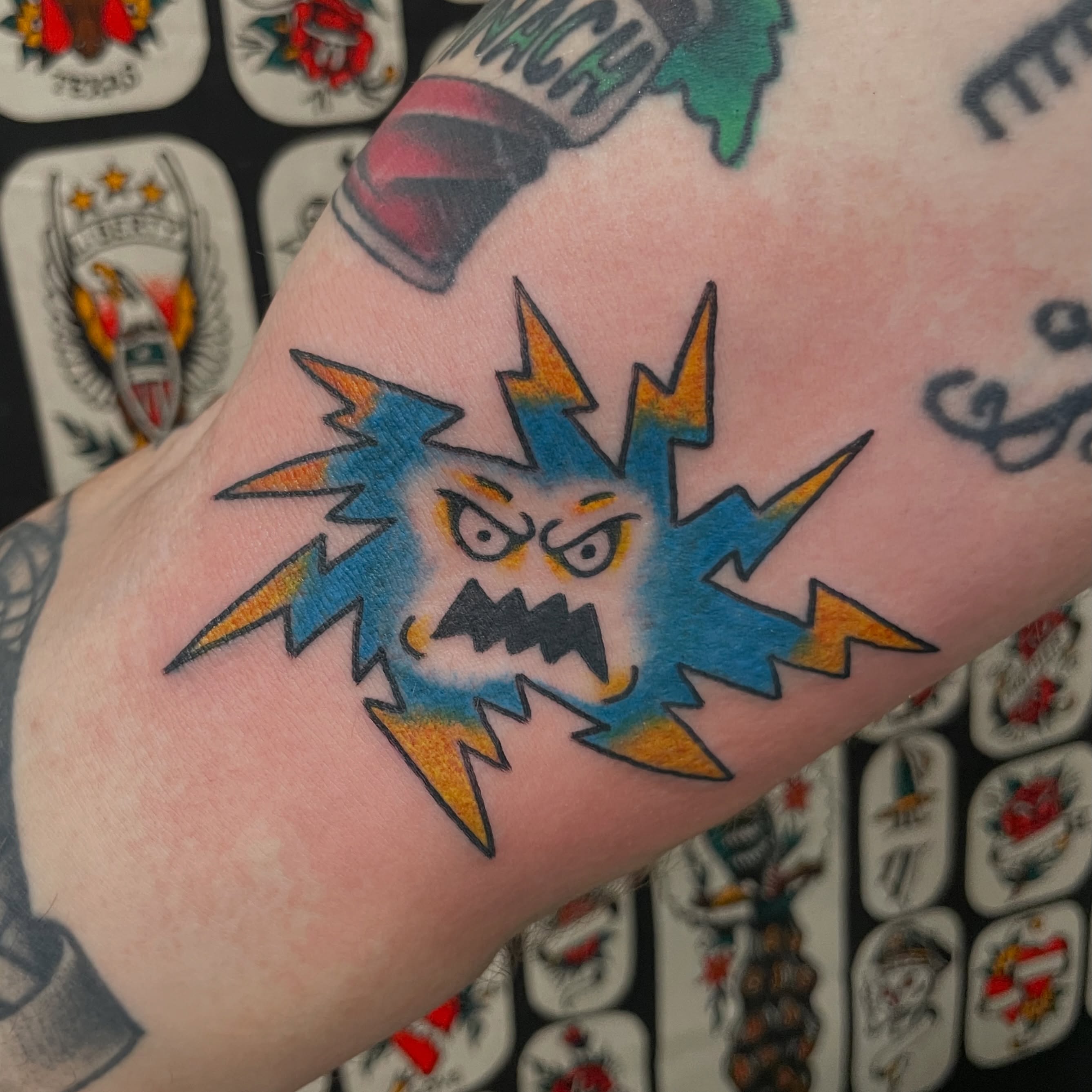 Angry lightning bolt American traditional tattoo on the forearm by Greg De Hoot, Youngsville, North Carolina