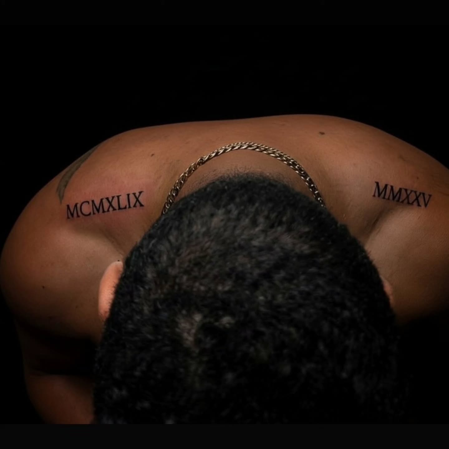 Roman numerals black and grey tattoo on the back by Tony