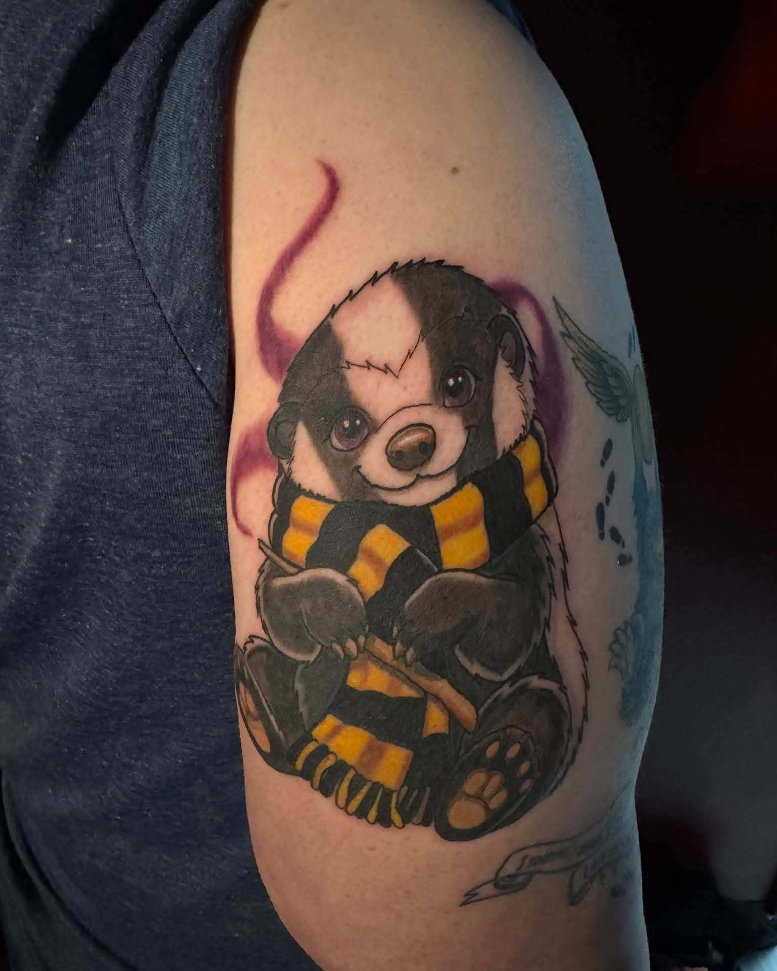 Badger wearing scarf realism tattoo on the forearm by Sabrina