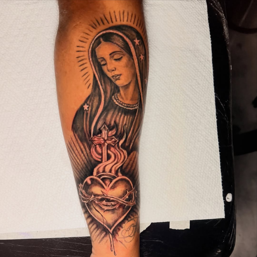 Religious figure American traditional tattoo on the forearm by Junior Sanchez Dfw