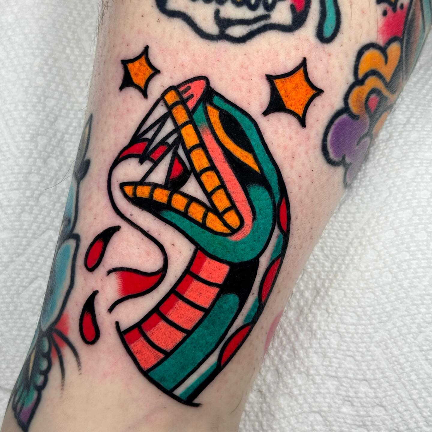 Snake American traditional tattoo on the forearm by Jess Baker