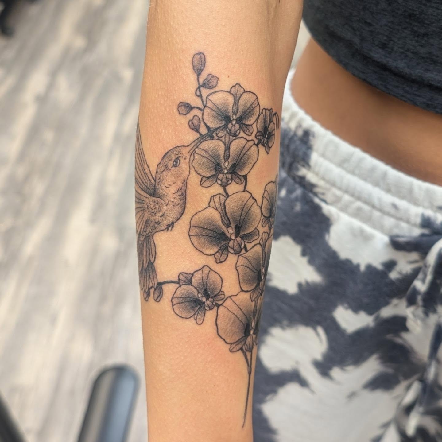 Hummingbird and orchids realism tattoo on the forearm by Talia Zula, Loveland, Ohio
