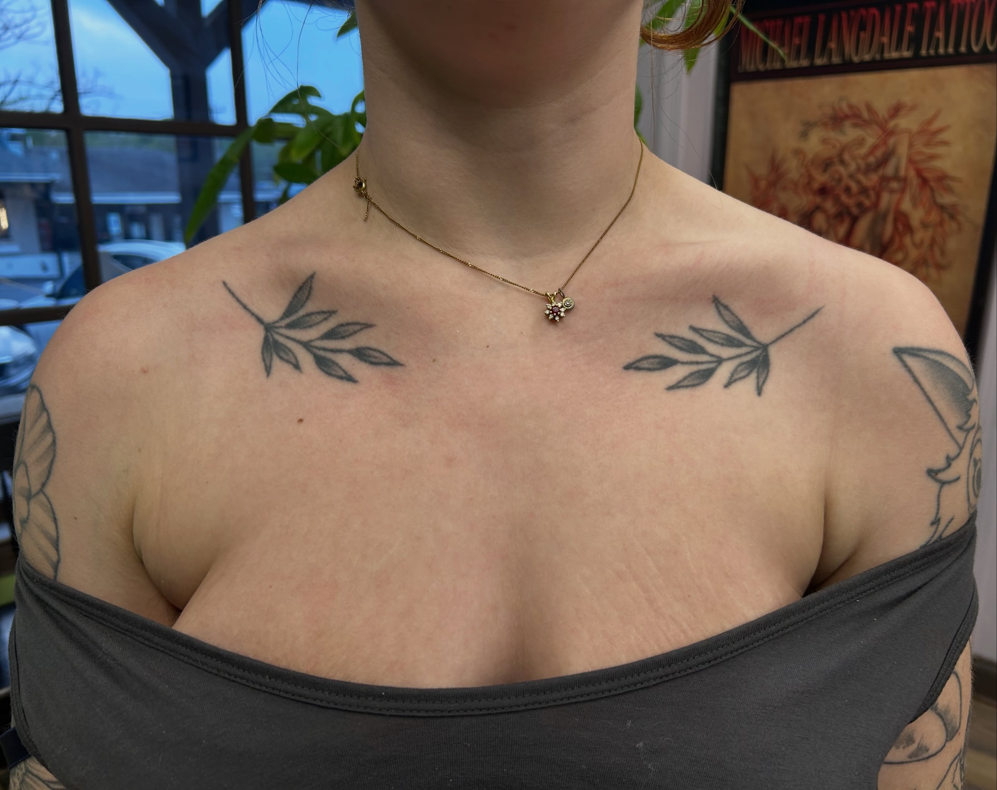Olive branch black and grey tattoo on the chest by Courtney