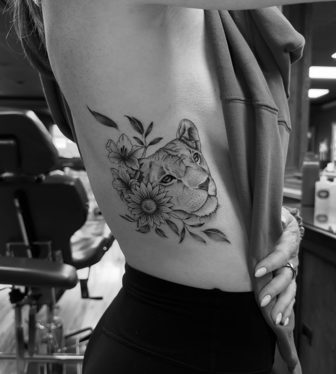 Lioness with flowers realism tattoo on the thigh by Leo Fernandes, Danvers, Massachusetts