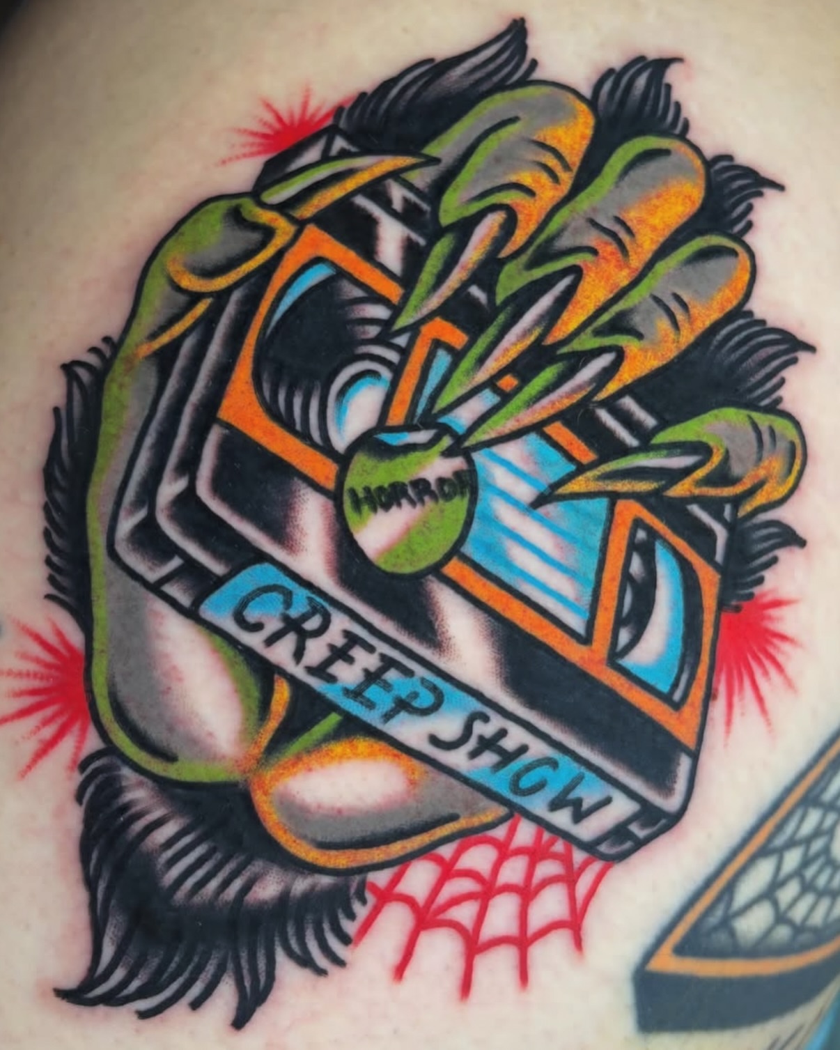 Creep Show American traditional tattoo on the upper arm by Zoe Margot