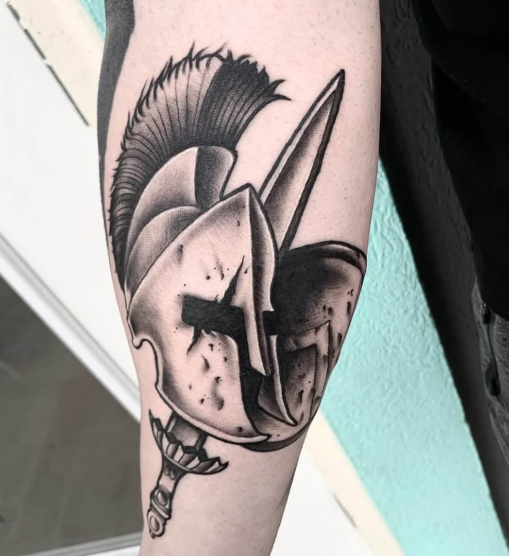 Spartan helmet black and grey tattoo on the forearm by Brandon Harrison, Kansas City, Missouri