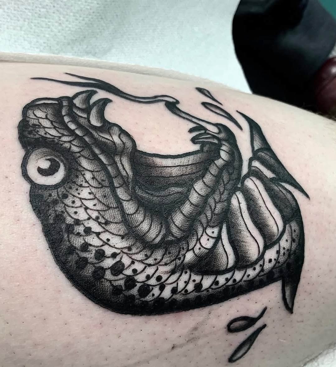 Snake black and grey tattoo on the upper arm by Brandon Harrison, Kansas City, Missouri