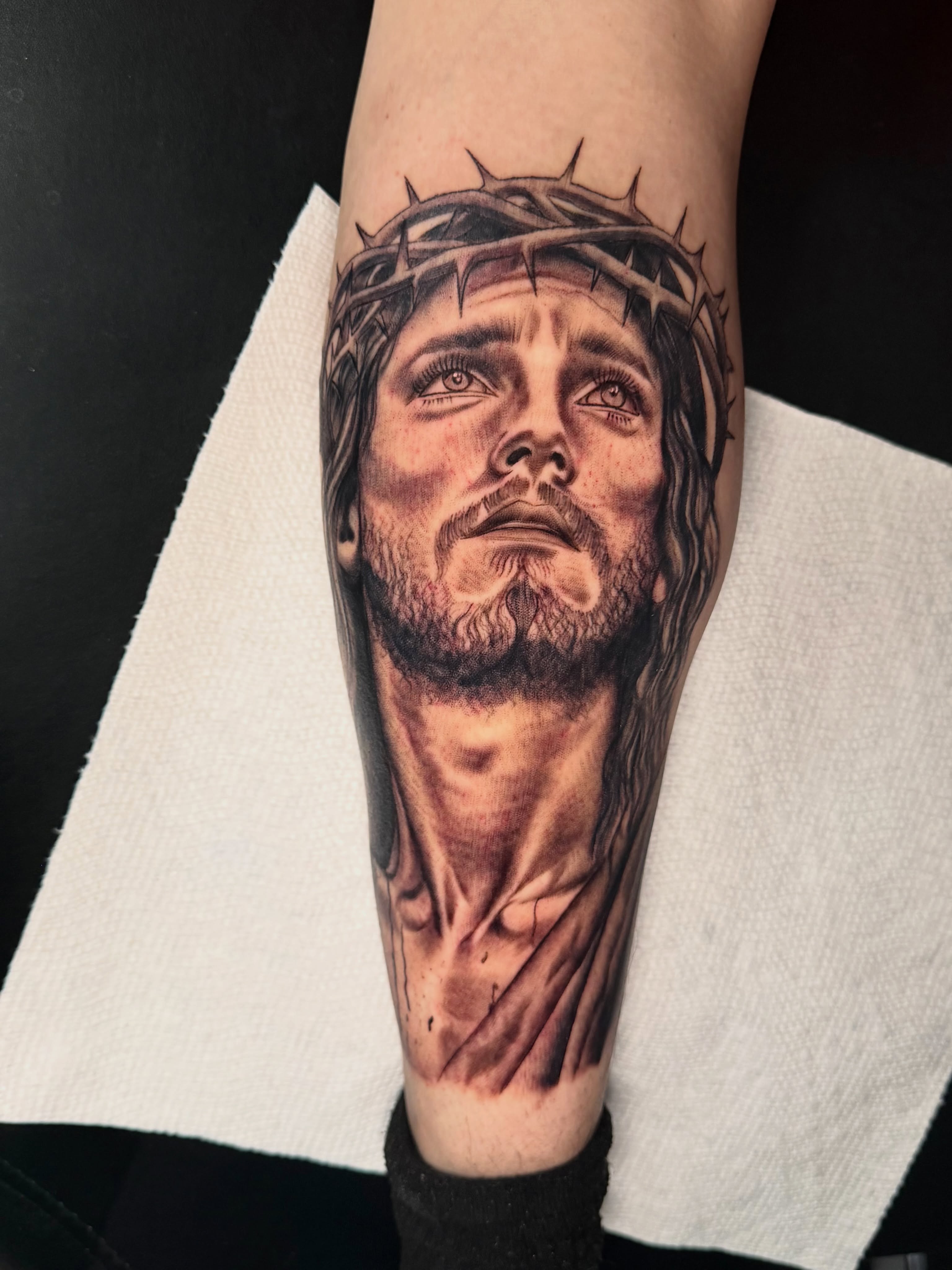 Religious figure realism tattoo on the forearm by Kimberly landin