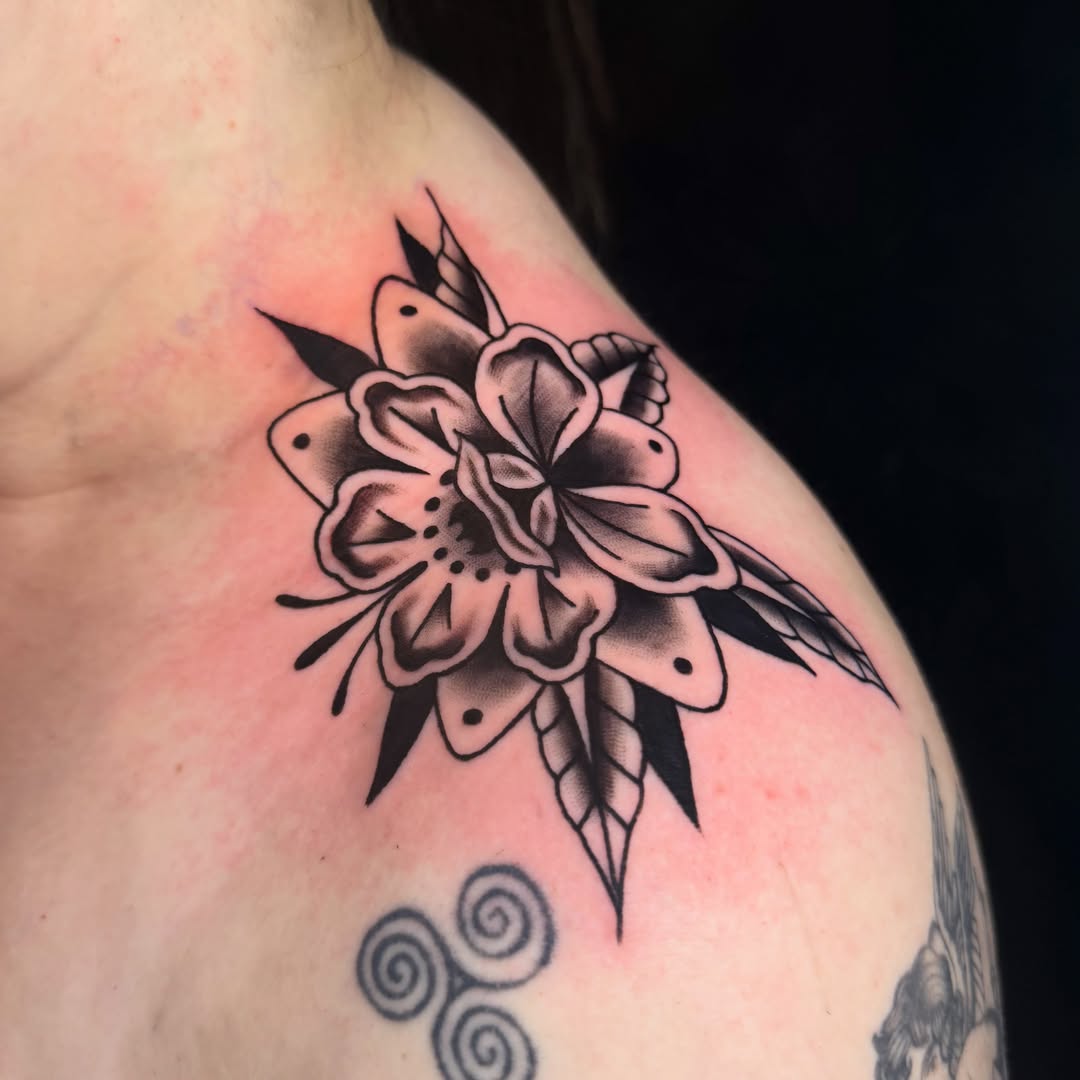 Flower American traditional tattoo on the shoulder by Shelby
