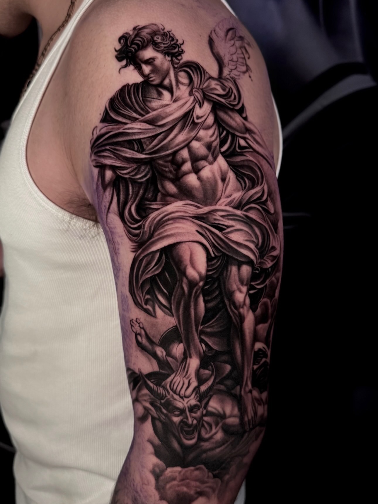 Angel and demon realism tattoo on the forearm by Yudel