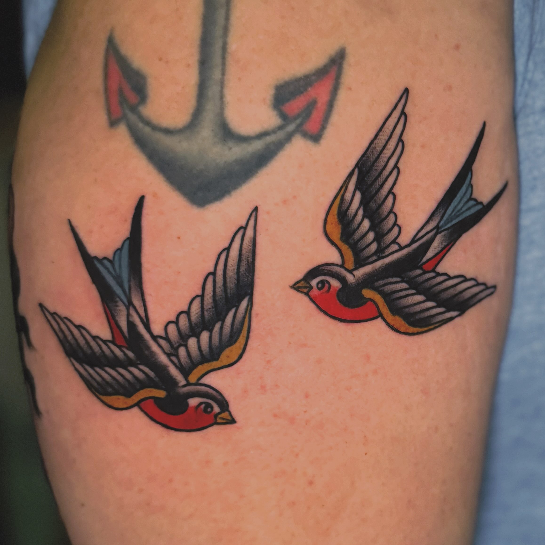 Swallows American traditional tattoo on the forearm by Nikki Bee