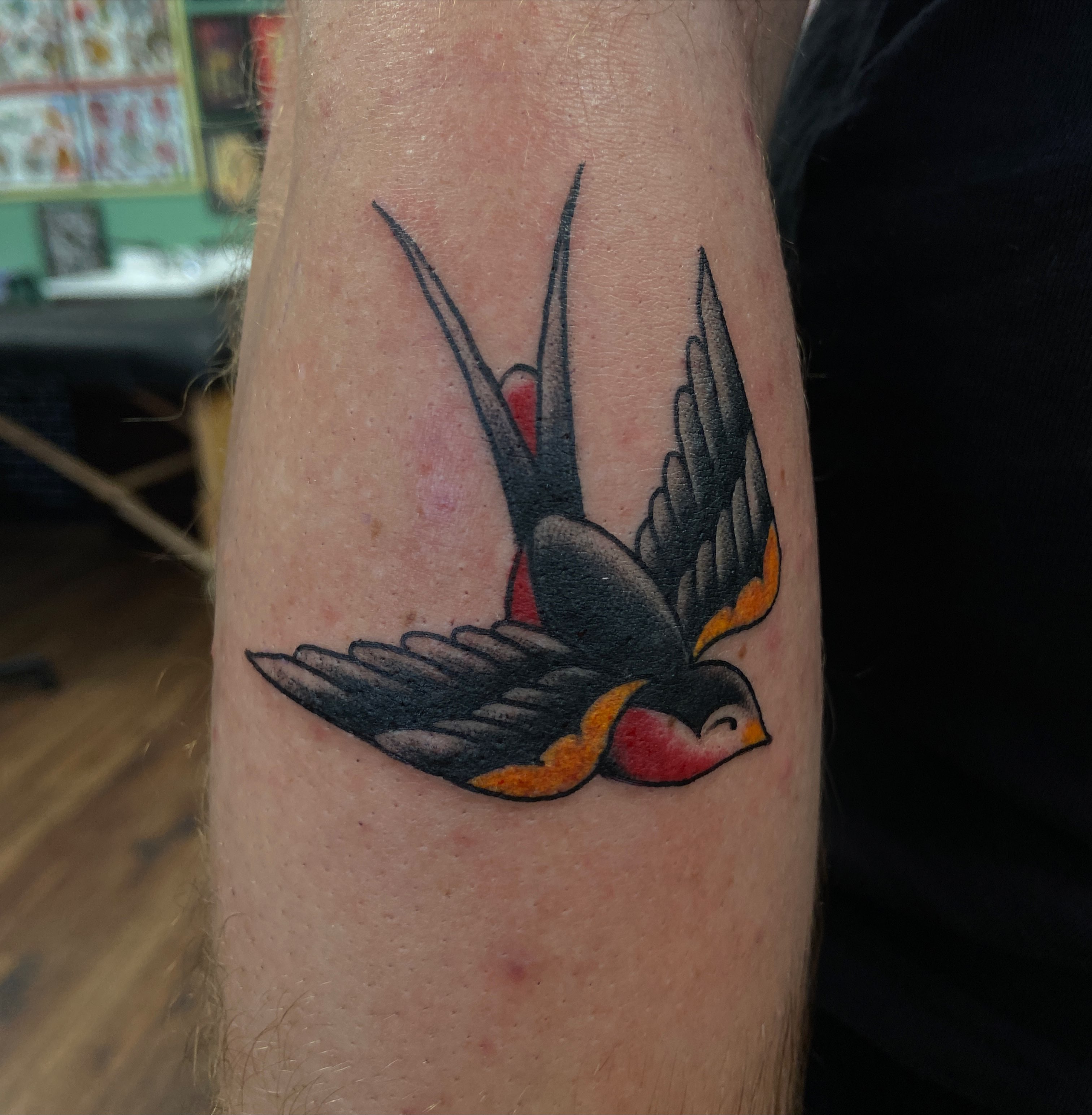 Swallow American traditional tattoo on the forearm by Lucía