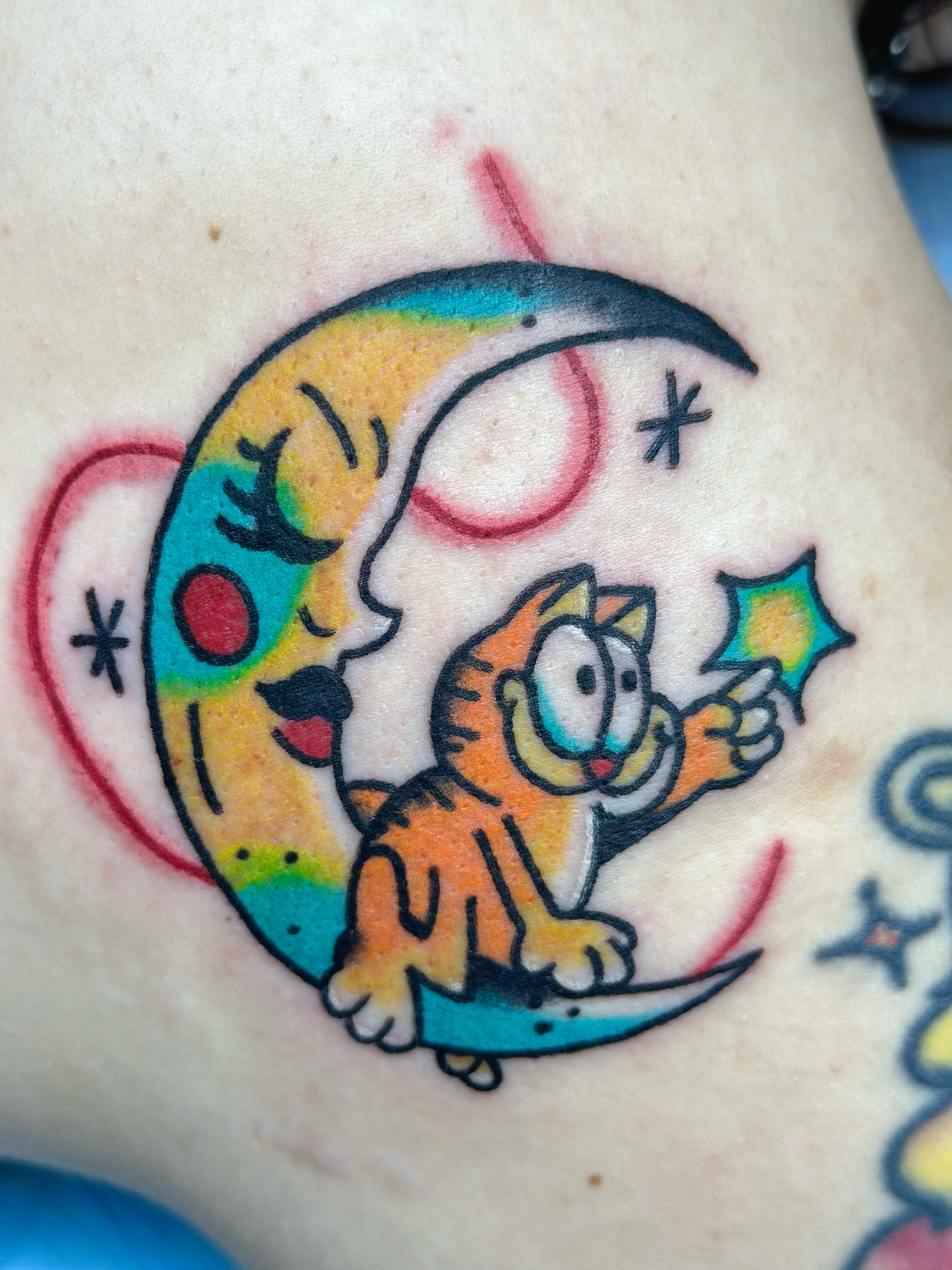 Garfield and moon American traditional tattoo on the forearm by Lucy Jay