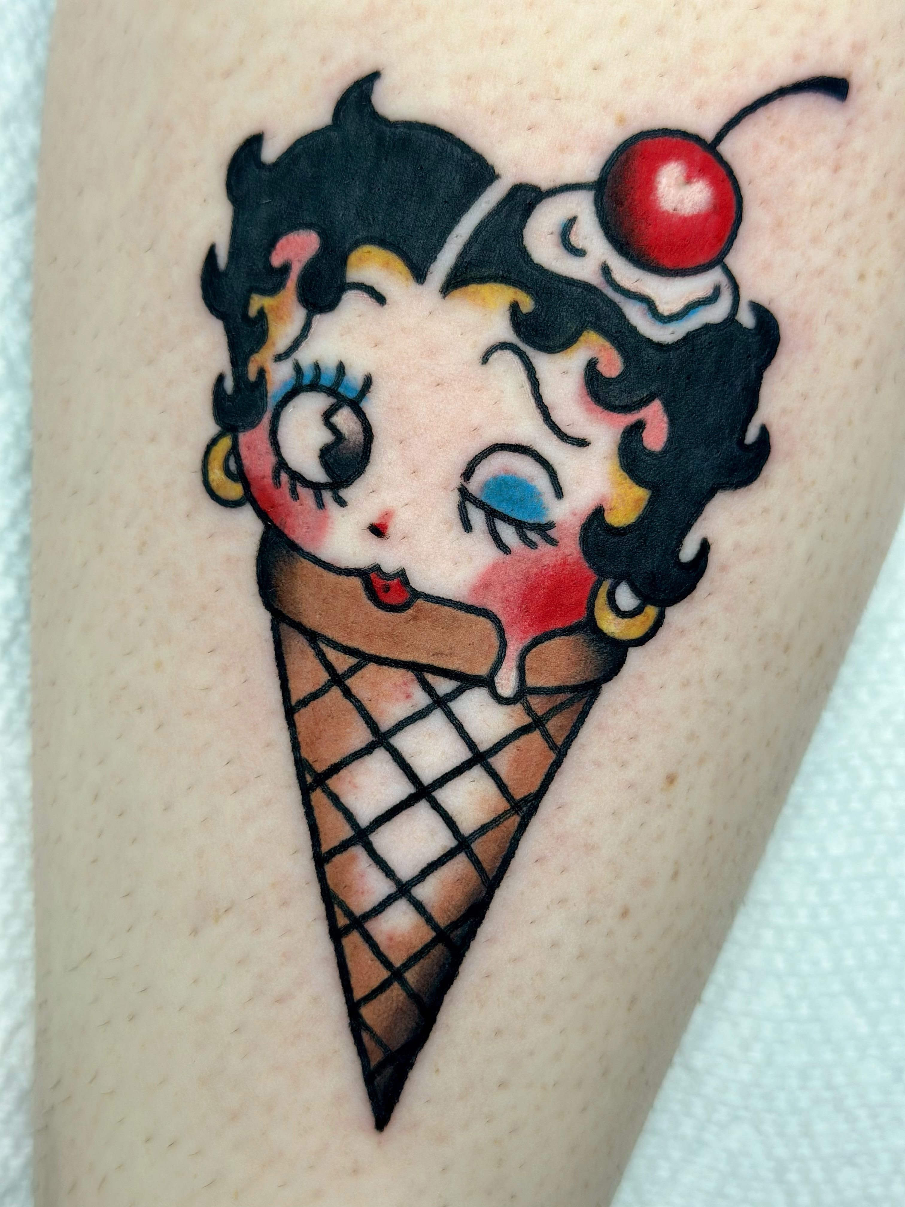 Betty Boop ice cream cone American traditional tattoo on the thigh by Lucy Jay
