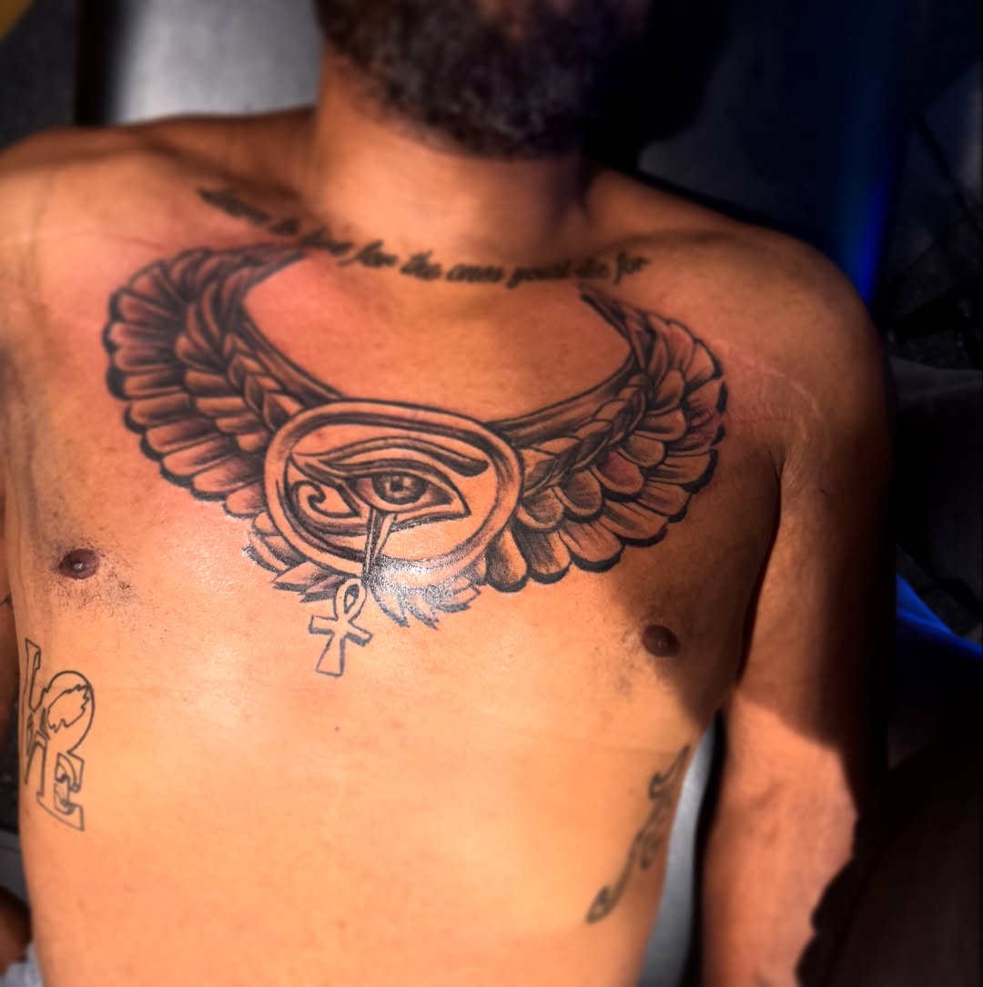 Eye with wings black and grey tattoo on the chest by Lamb, Philadelphia, Pennsylvania