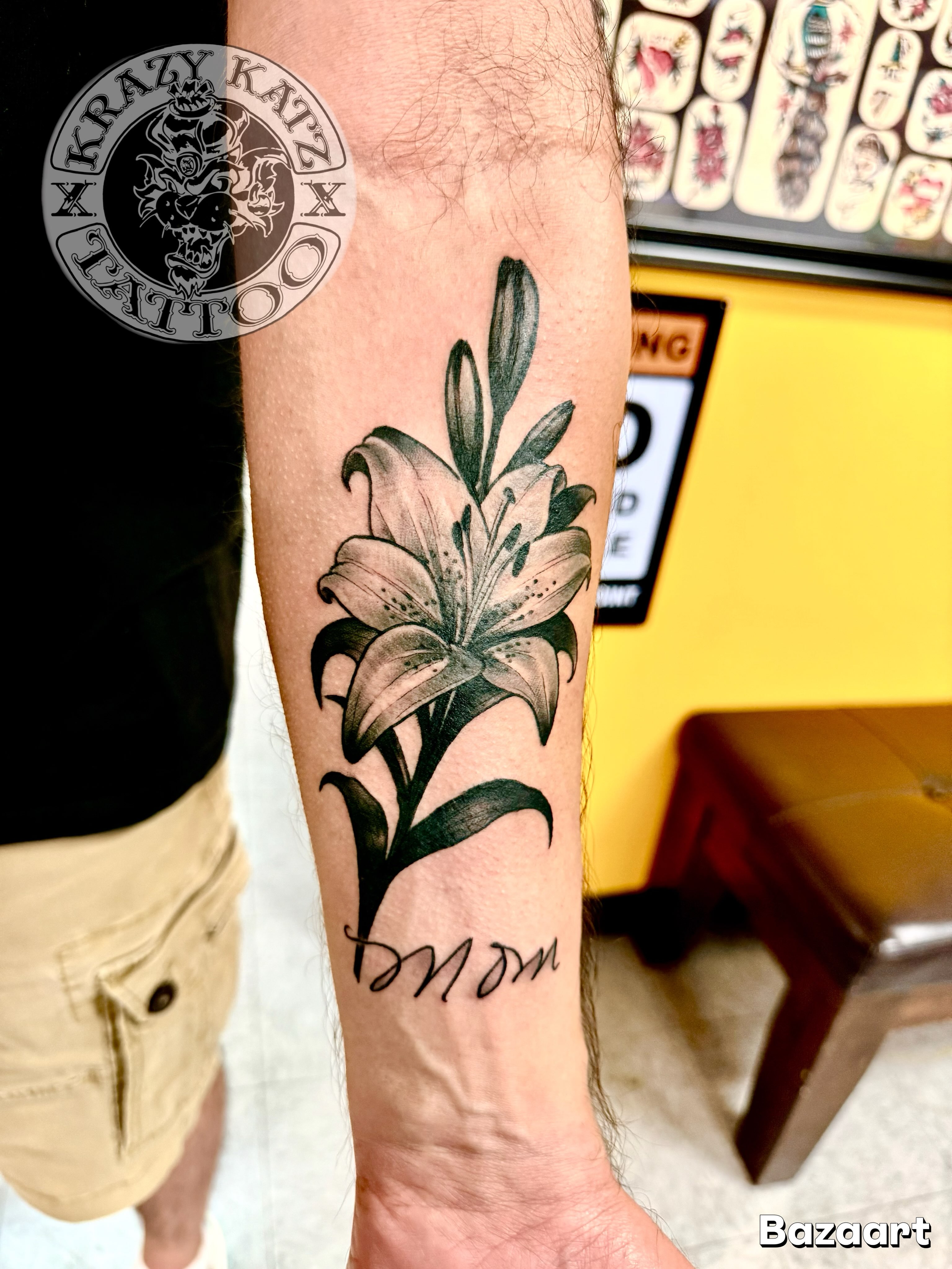 Lily black and grey tattoo on the forearm by Frank Gomez 🎨