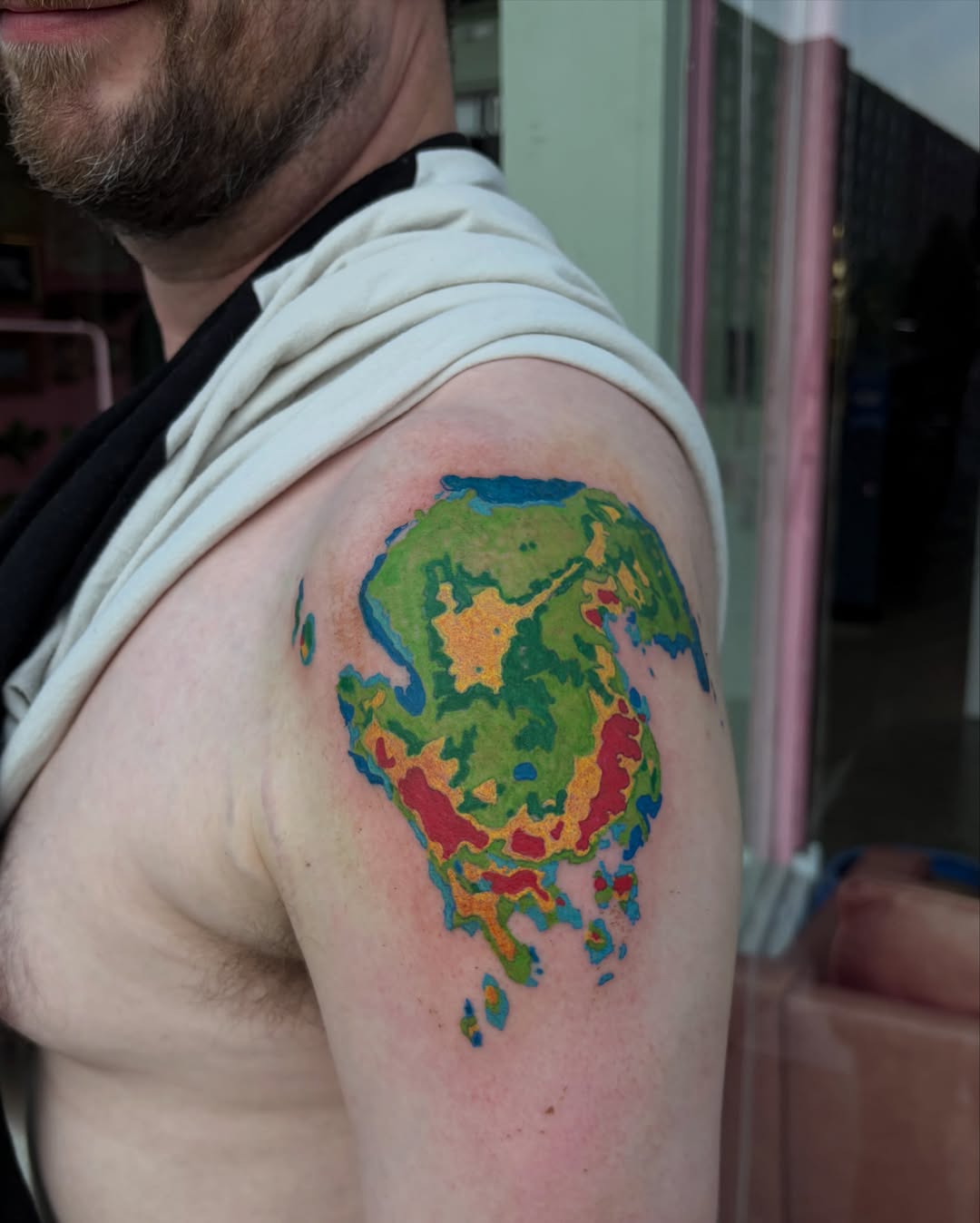 World map watercolor tattoo on the shoulder by neal