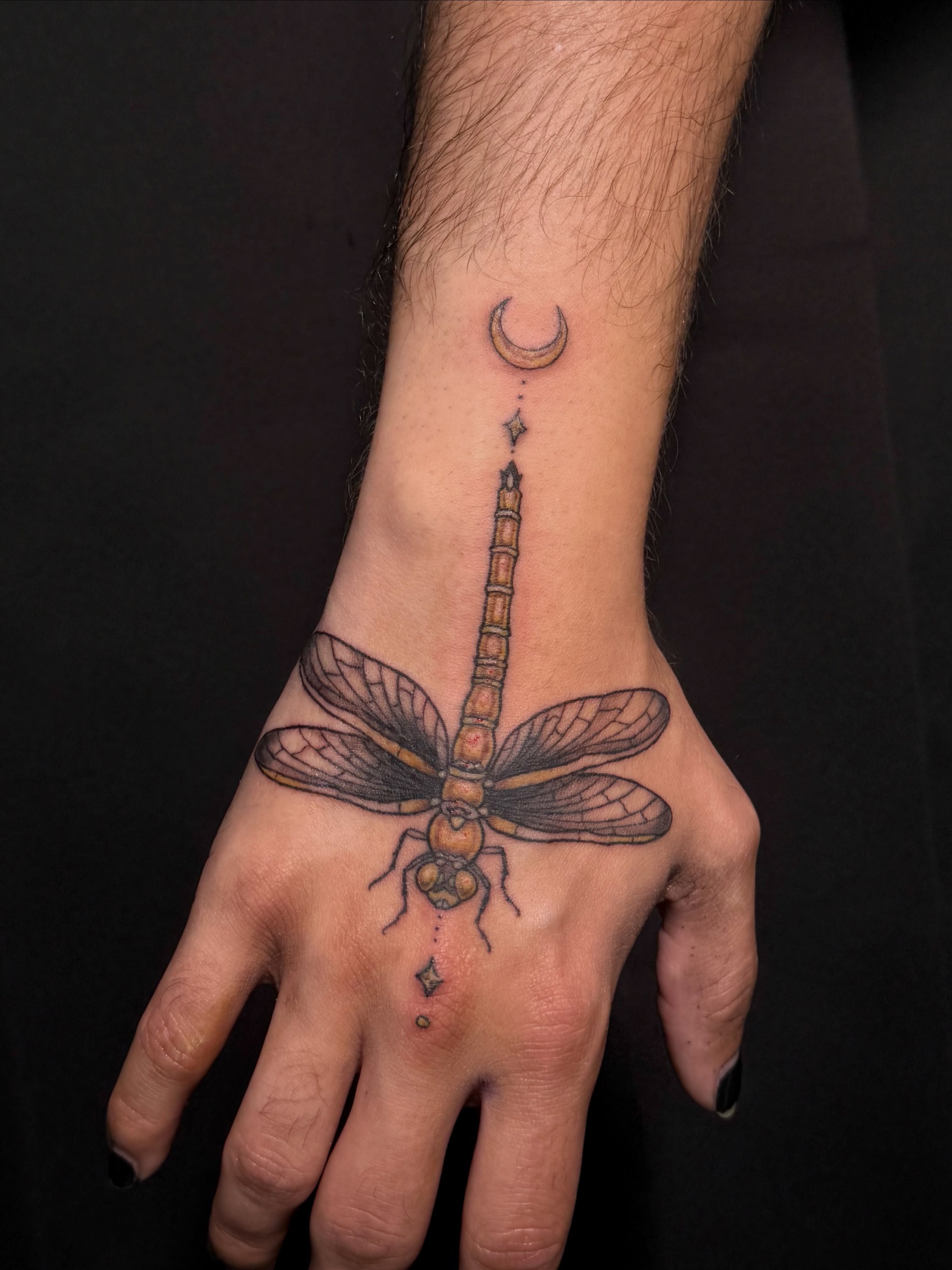 Dragonfly dotwork tattoo on the hand by Paris Romano