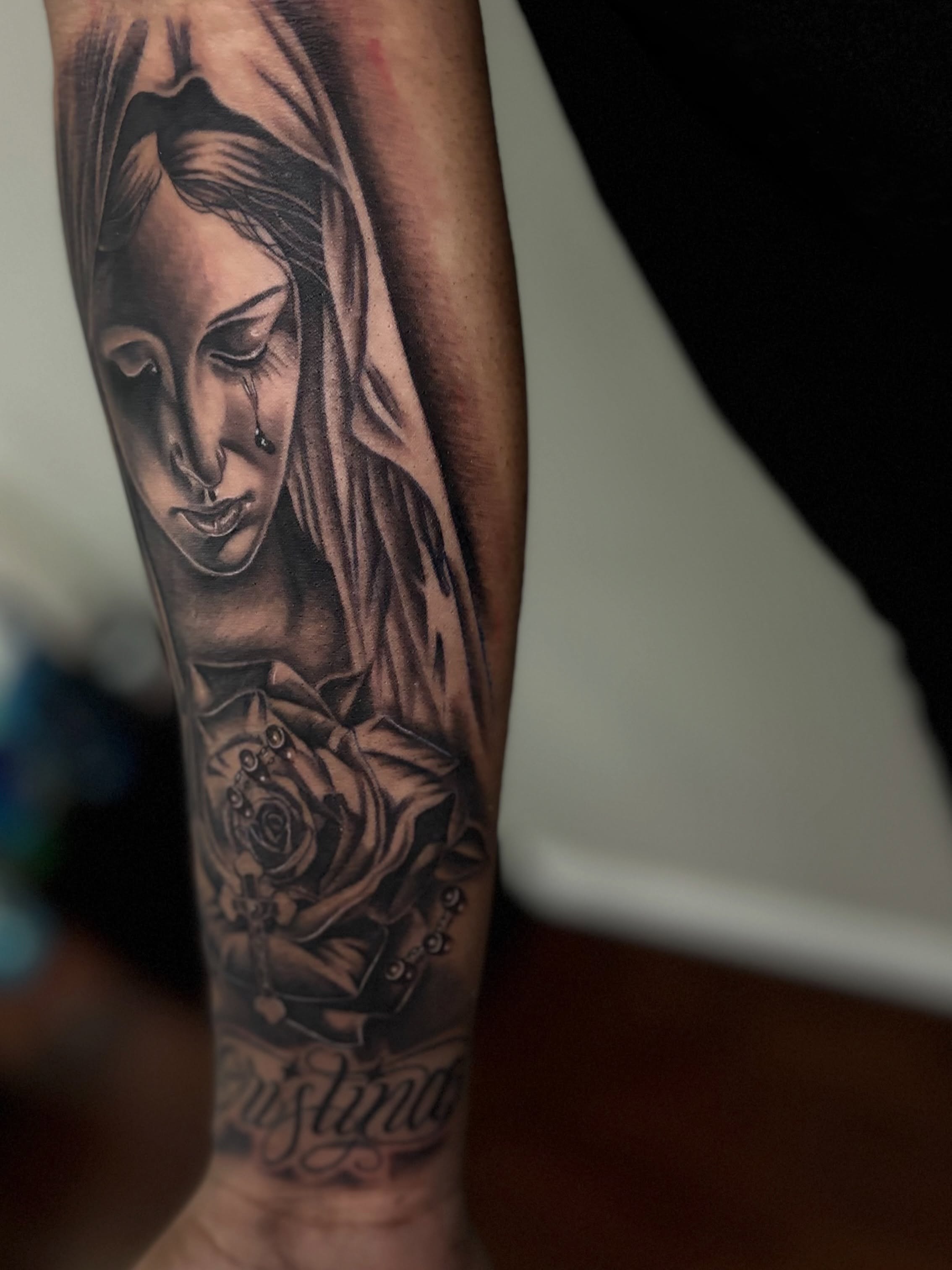 Woman with roses realism tattoo on the forearm by @tattoosbyadrian