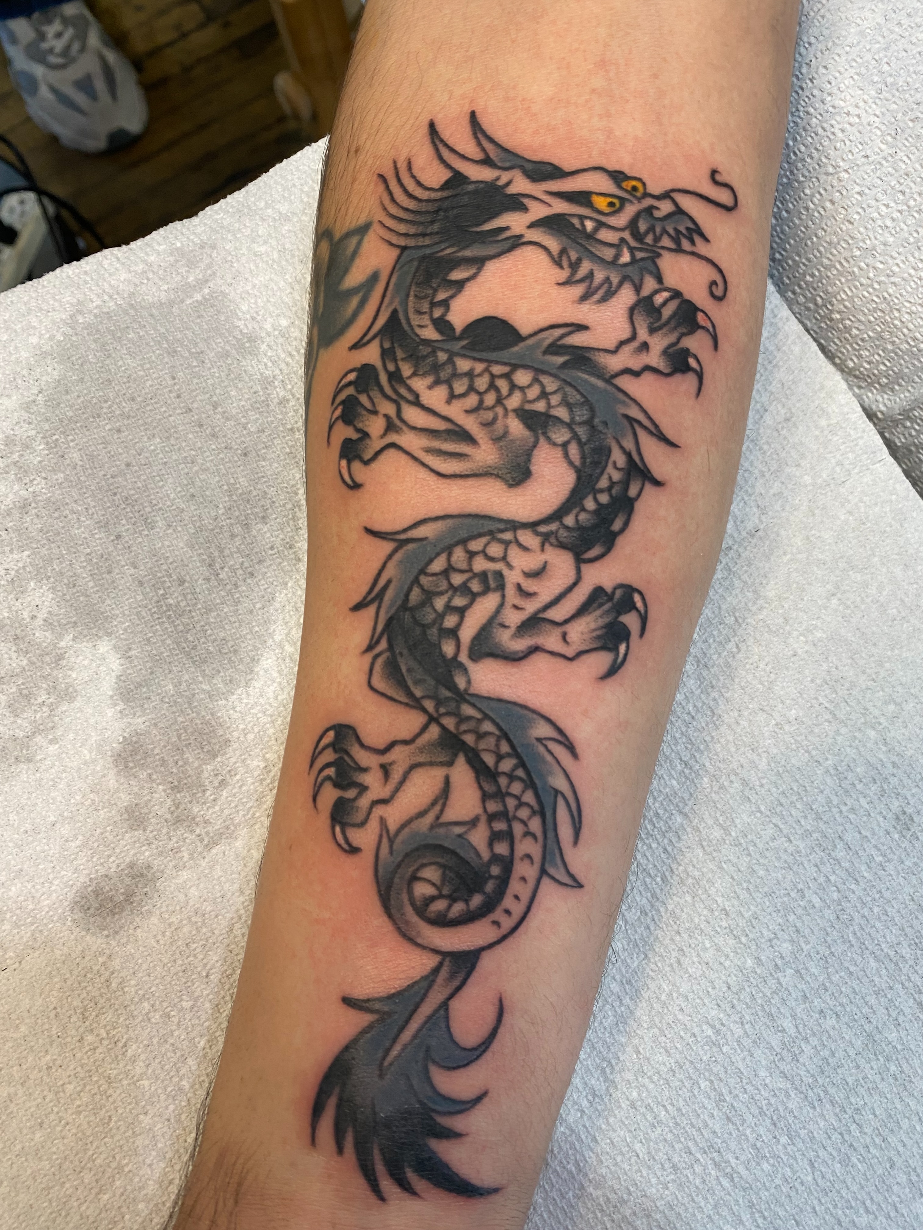Dragon black and grey tattoo on the forearm by Karl Hegwein, Portland, Oregon
