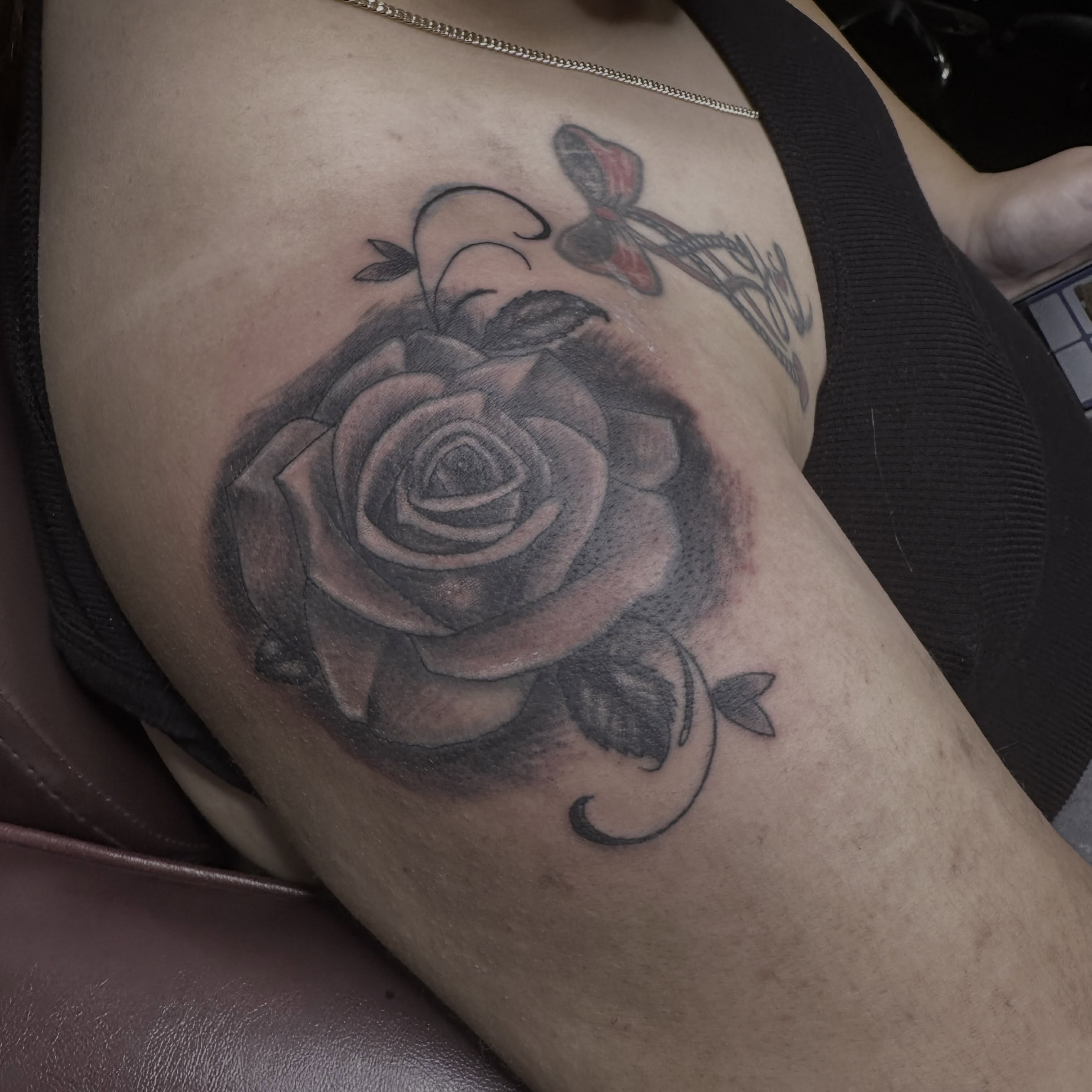 Rose realism tattoo on the thigh by Red (Owner), Brooklyn, New York
