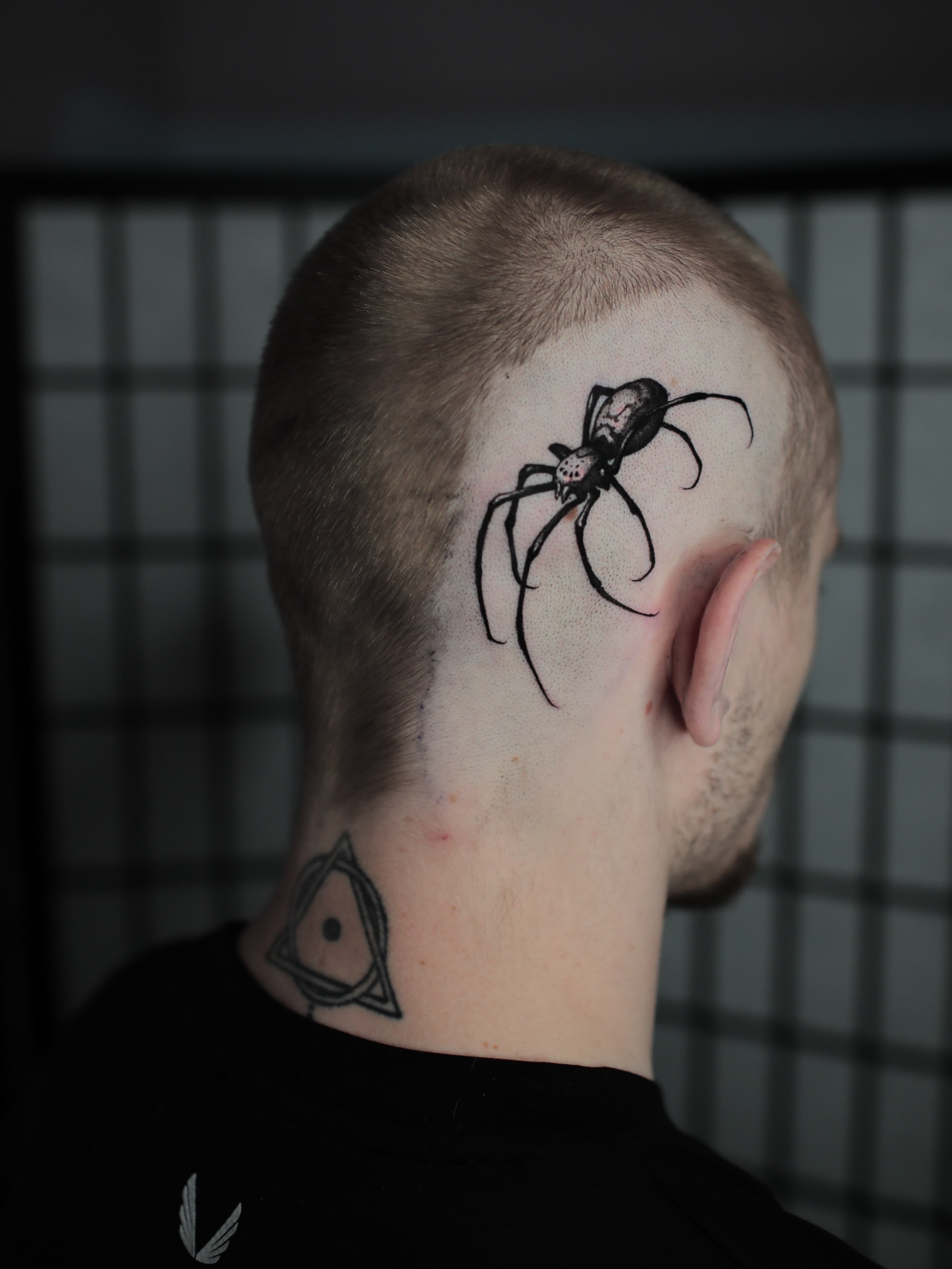 Spider black and grey tattoo on the neck by Strokin Konstantin