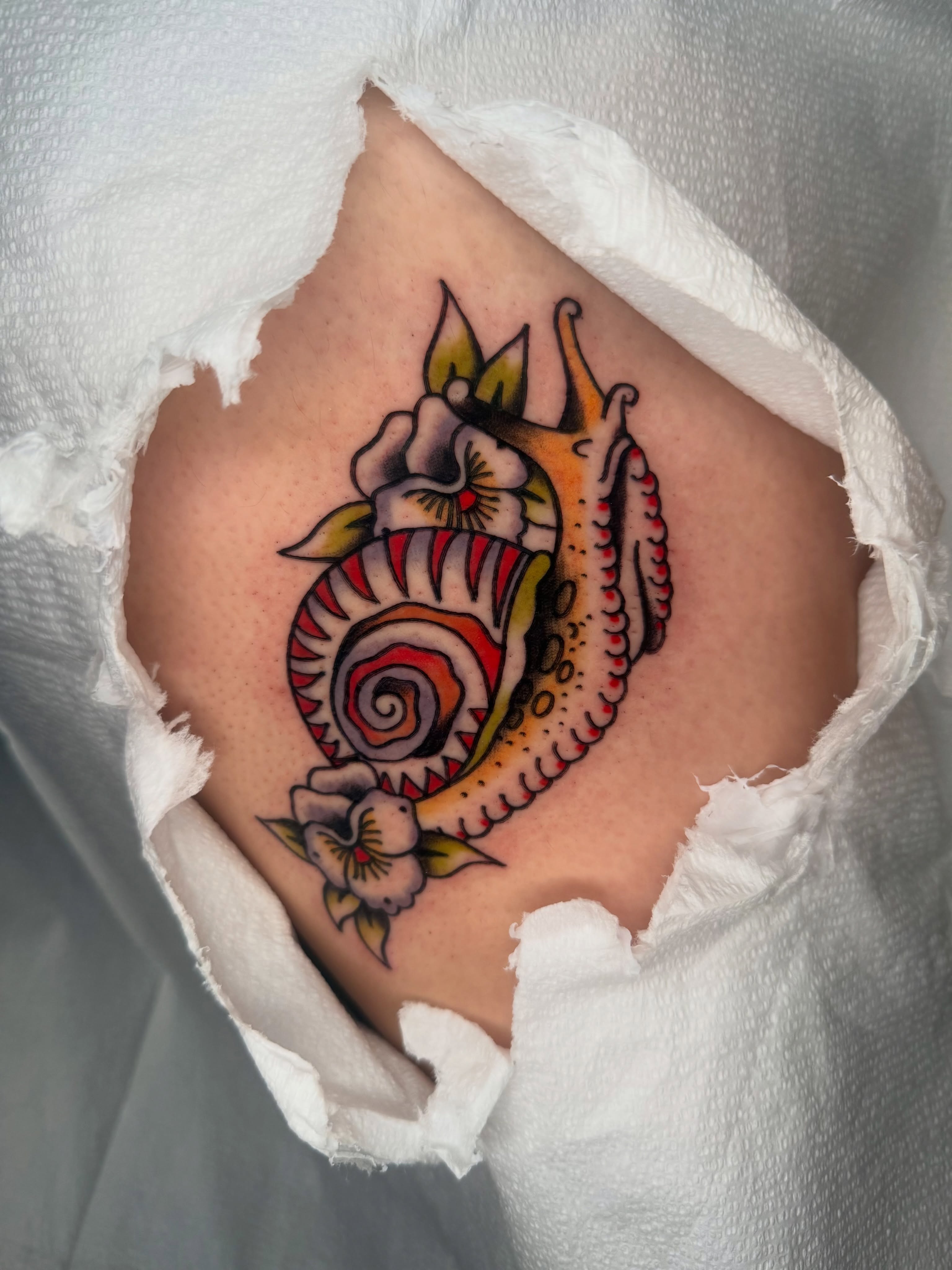 Seahorse and flowers American traditional tattoo on the thigh by Lexie Graff