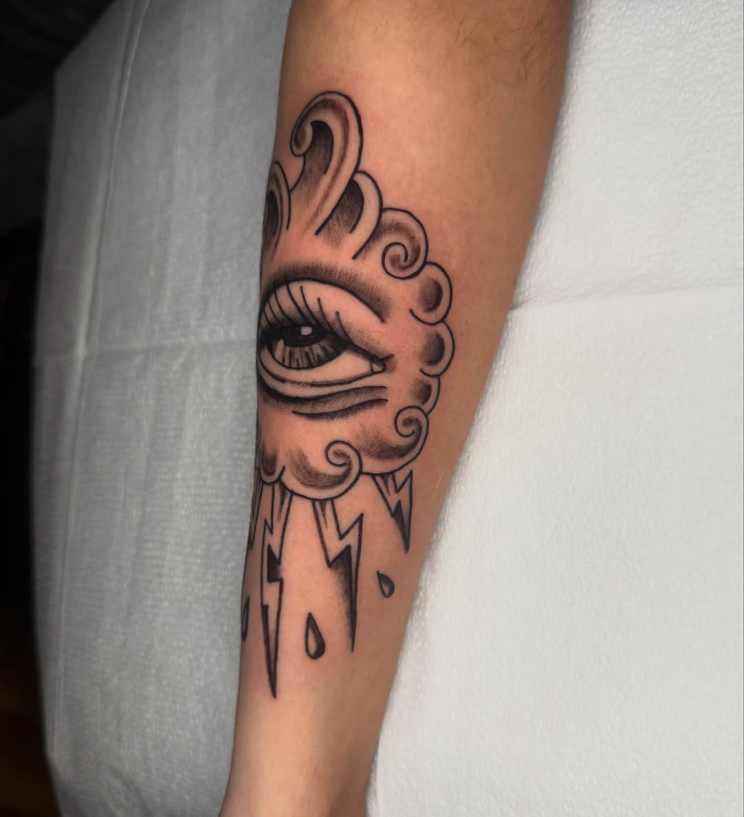 Eye with flame American traditional tattoo on the forearm by Lexie Graff