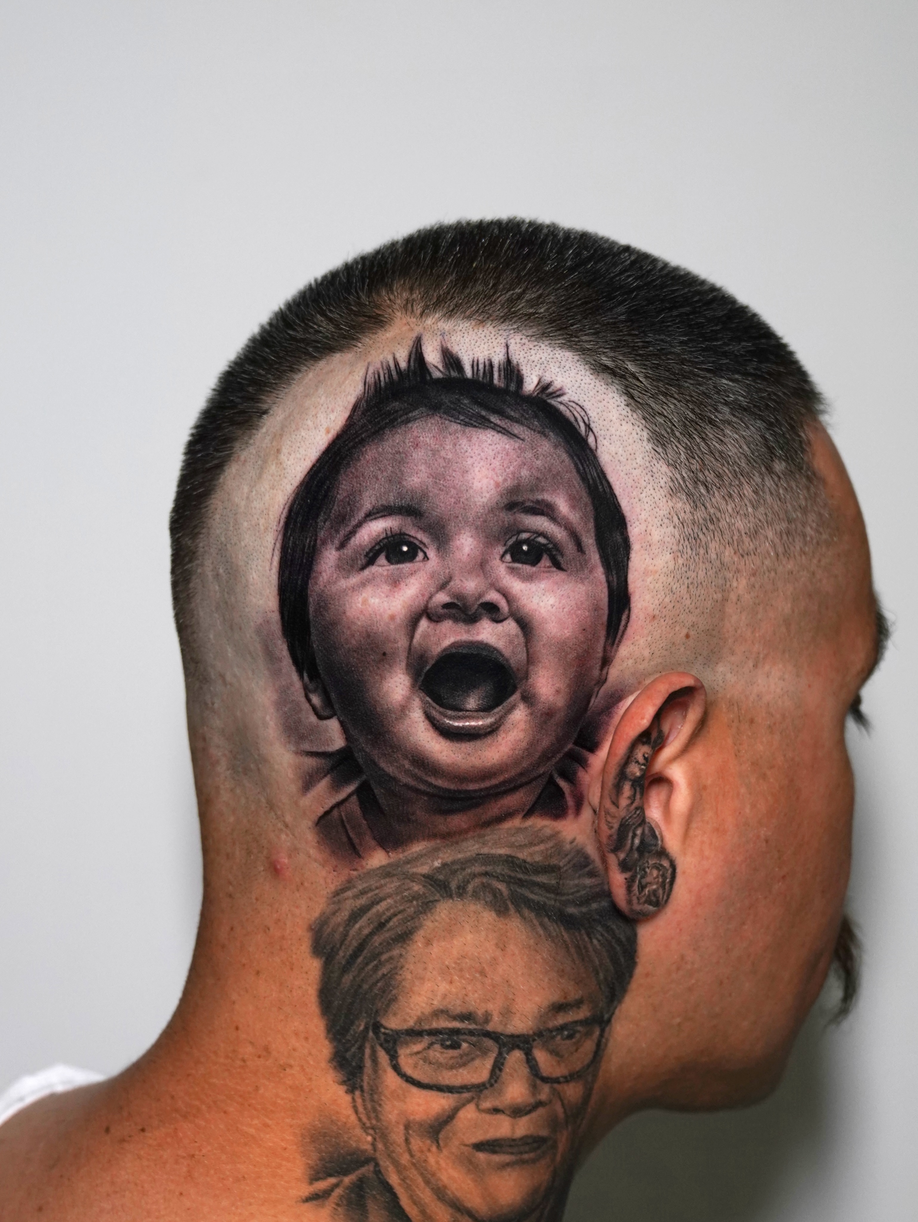Baby realism tattoo on the head by Luis Peña