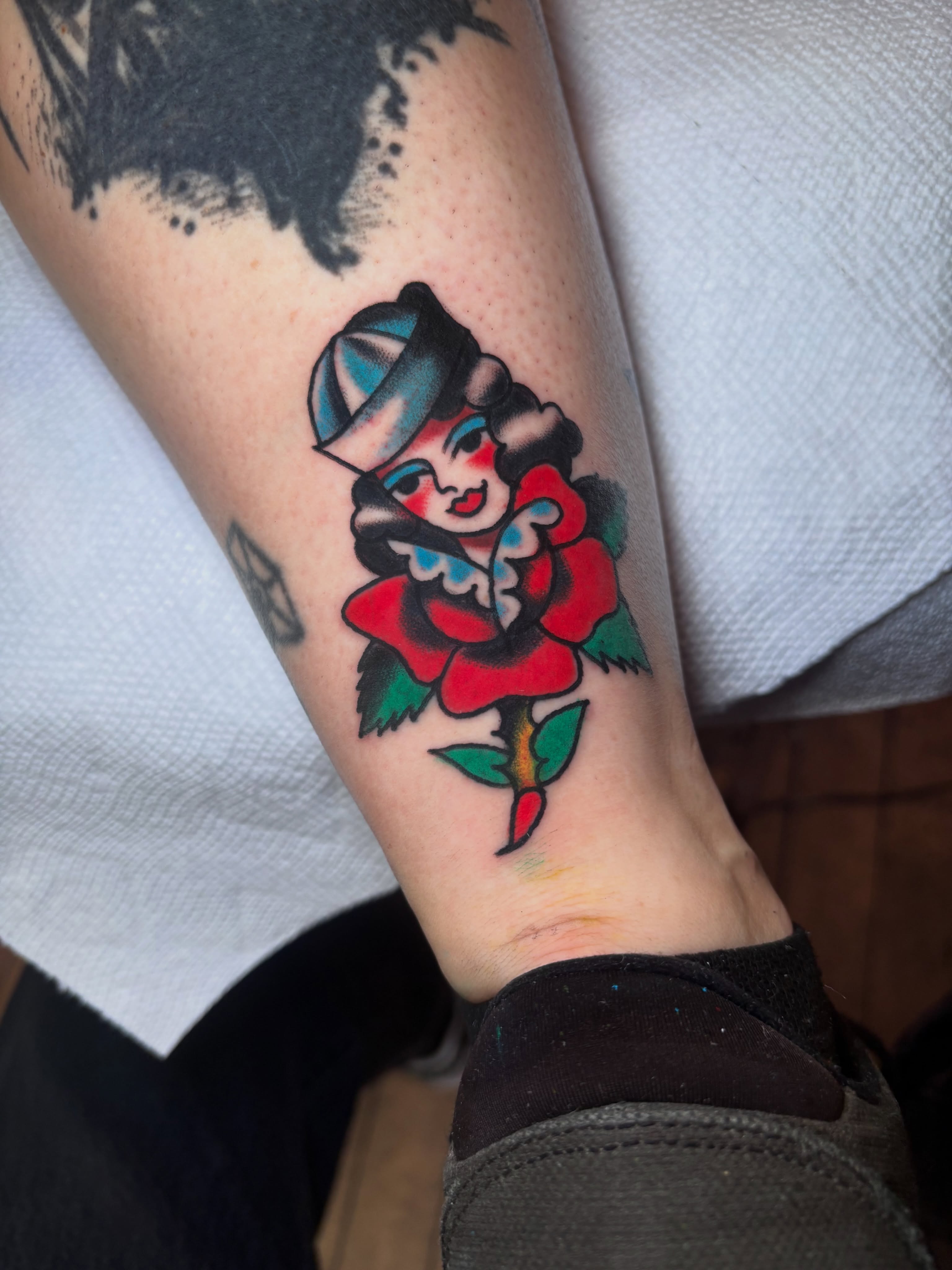 Rose with woman American traditional tattoo on the forearm by Nick