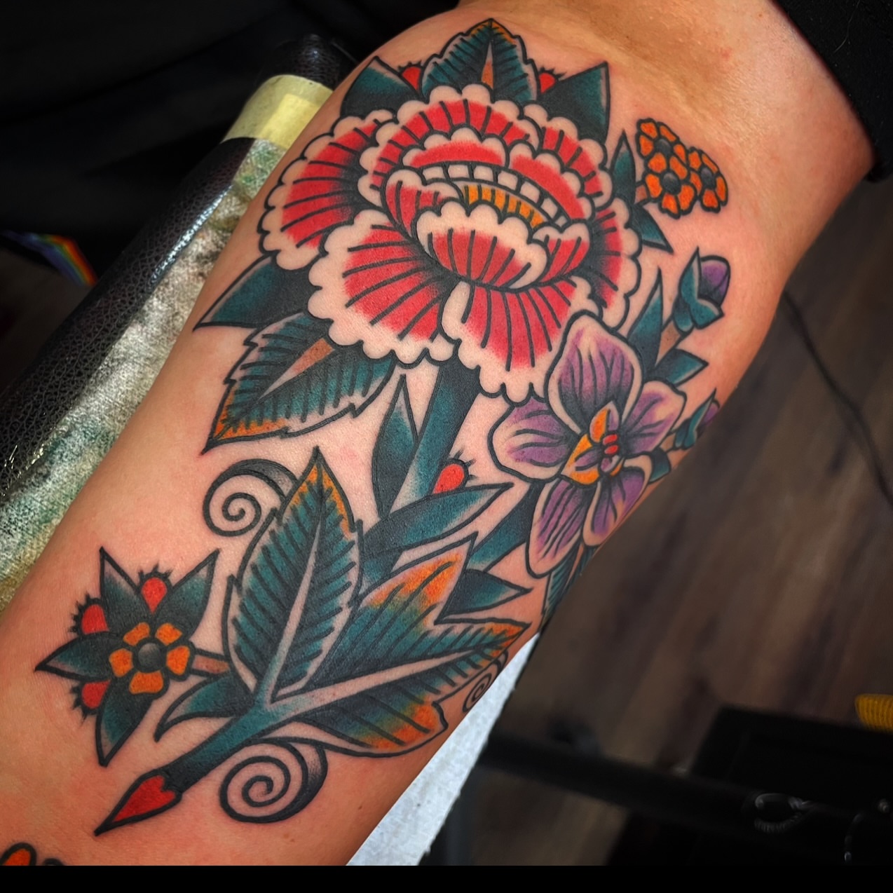 Floral arrangement American traditional tattoo on the thigh by Rogelio Robles